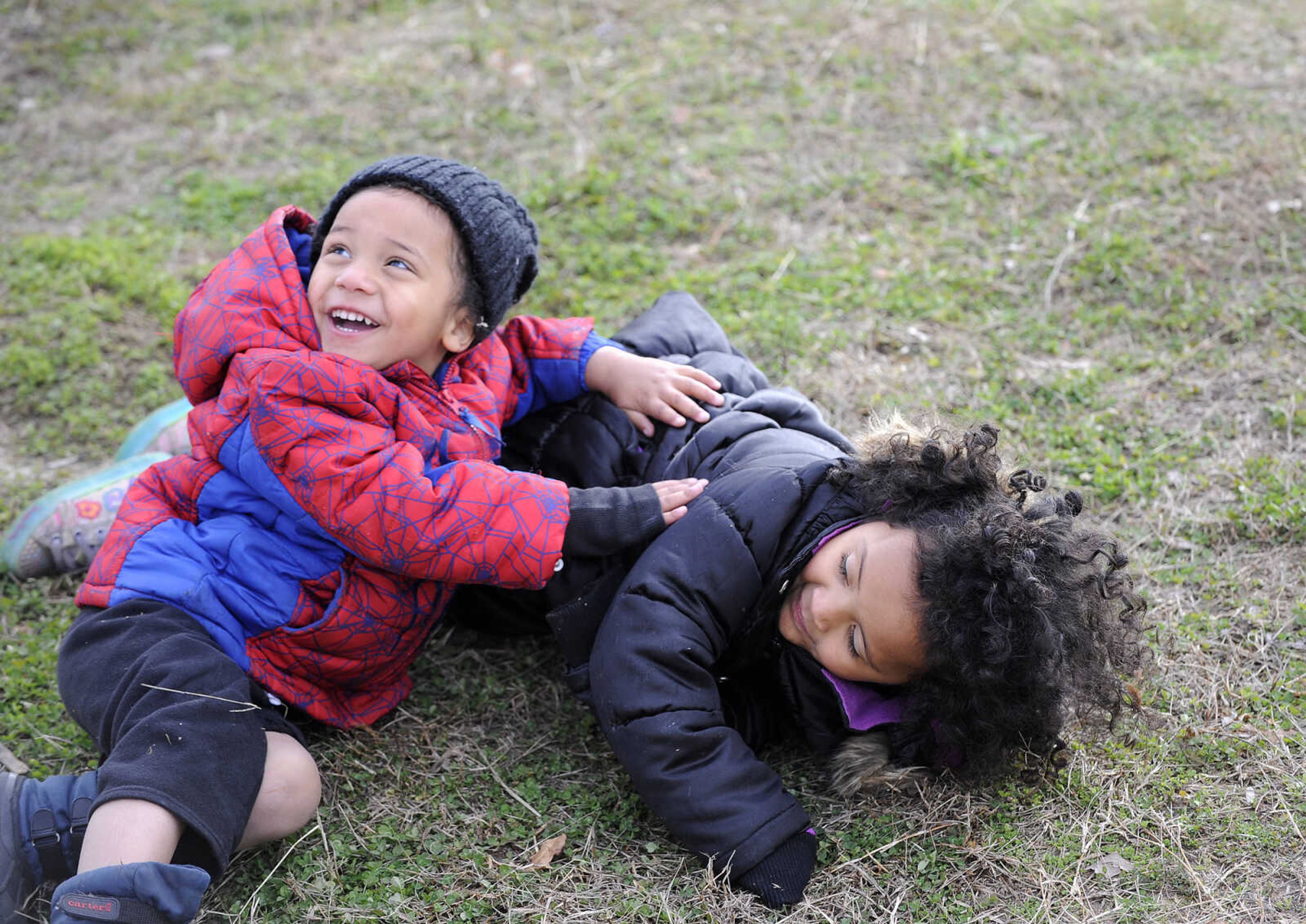 LAURA SIMON ~ lsimon@semissourian.com

Lathen Austin, 4, and his sister Lily, 5, roll around in the grass as American Red Cross make the children peanut butter and jelly sandwiches, Thursday, Dec. 31, 2015, in the Red Star District of Cape Girardeau.