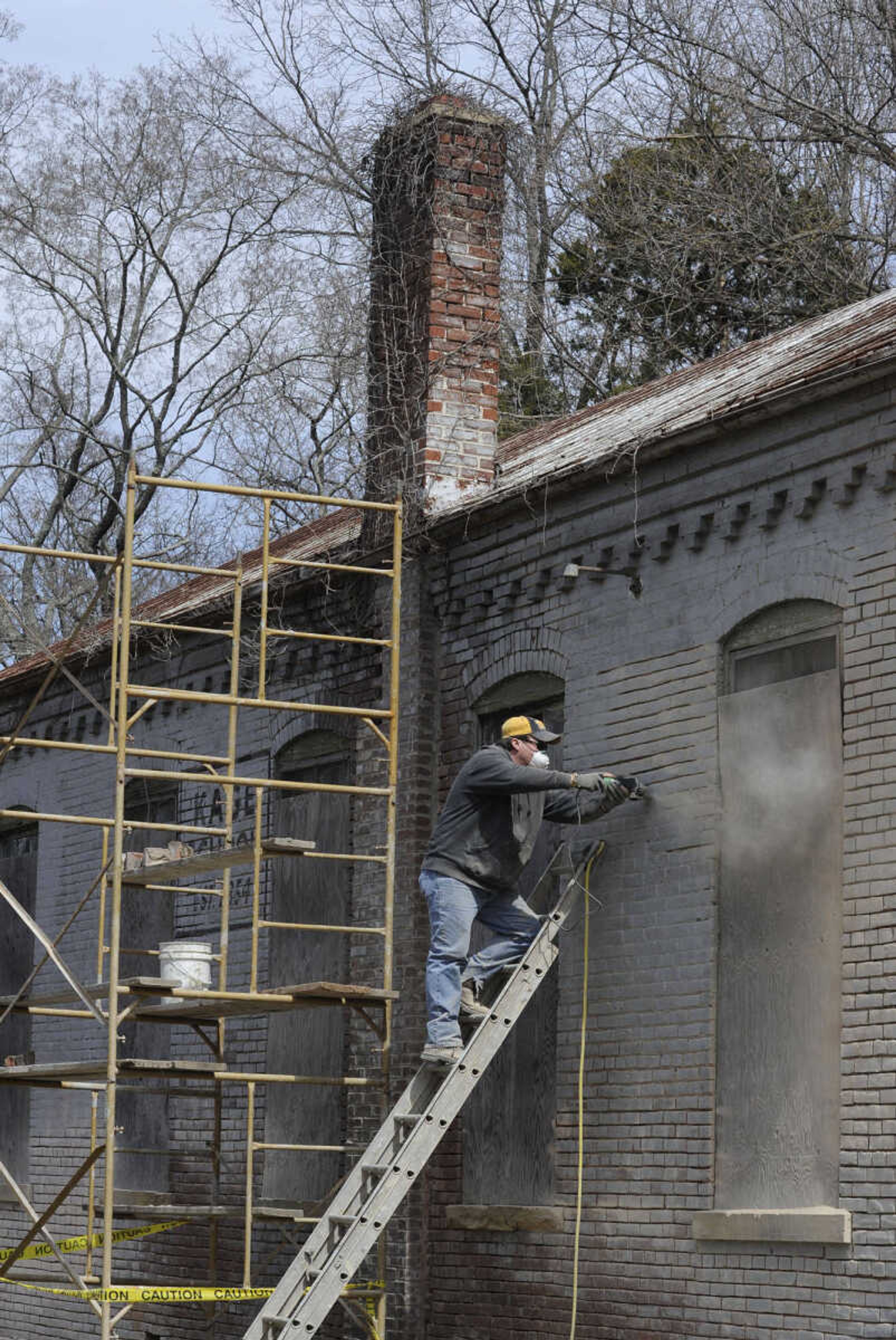 FRED LYNCH ~ flynch@semissourian.com
Justin Wissmann with Langston Masonry & Construction grinds out joints in the brick wall of the old Kage School in preparation for tuckpointing on Monday, March 24, 2014 in Cape Girardeau.