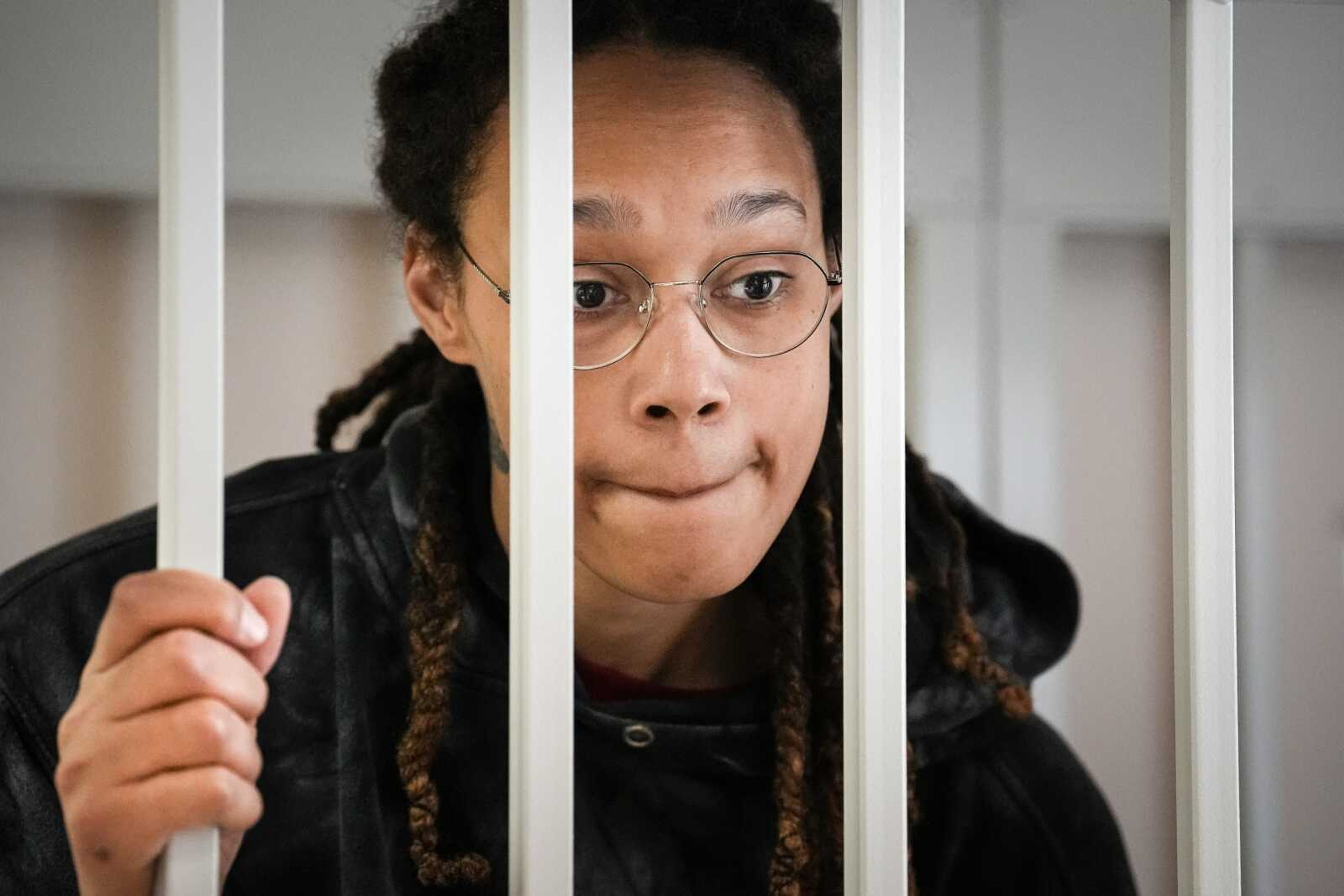 WNBA star and two-time Olympic gold medalist Brittney Griner speaks to her lawyers standing in a cage at a court room prior to a hearing July 26 in Khimki just outside Moscow, Russia.