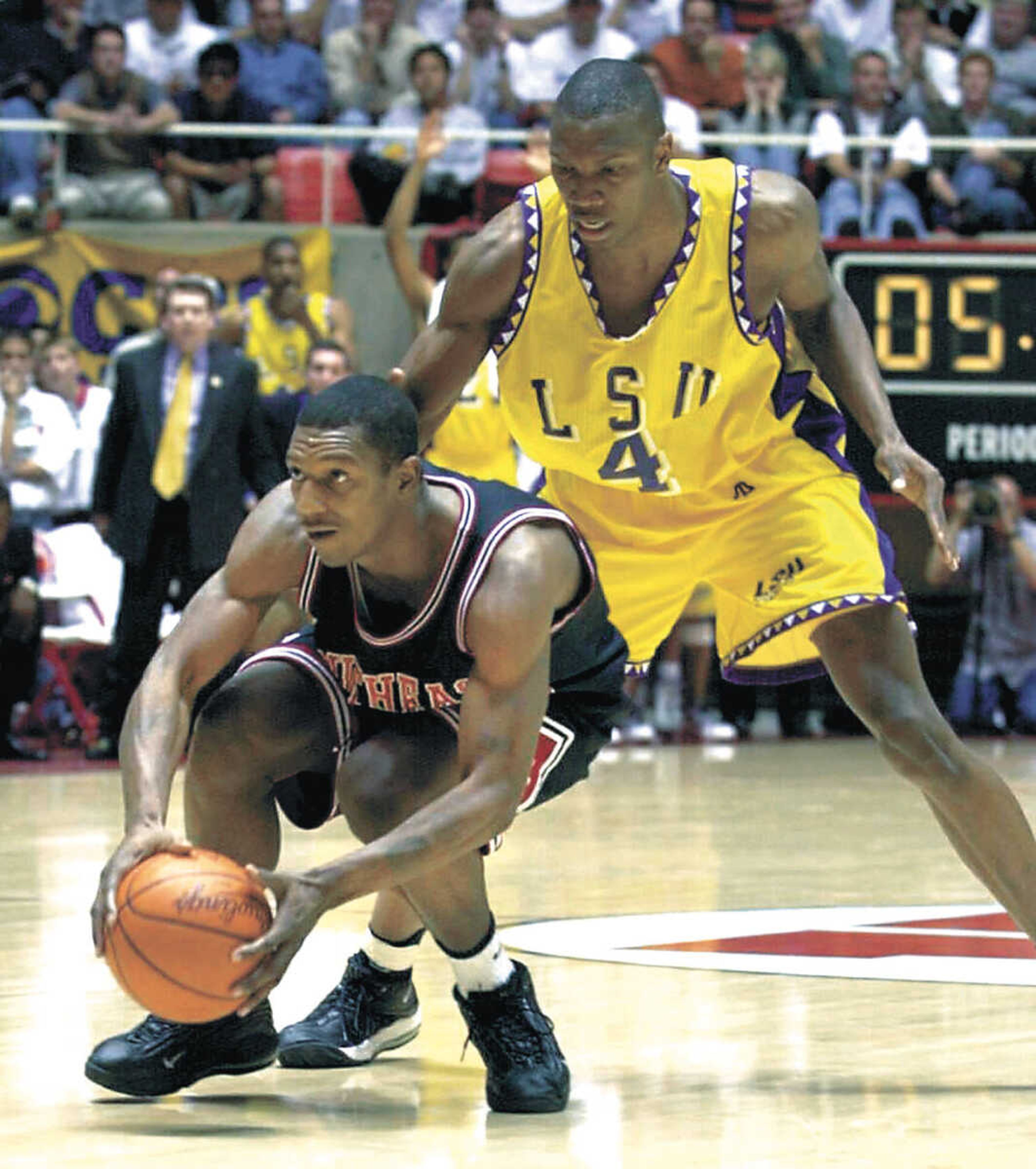 Southeast Missourian/ Fred Lynch
With LSU's Stromile Swift on his back, and just five seconds left to play, Southeast Missouri's Roderick Johnson eyed the basket seconds before putting up his team's final shot, a 3-pointer, on March 16, 2000 in Salt Lake City, Utah. The shot, from the top of the key, fell just short and would have tied the game.