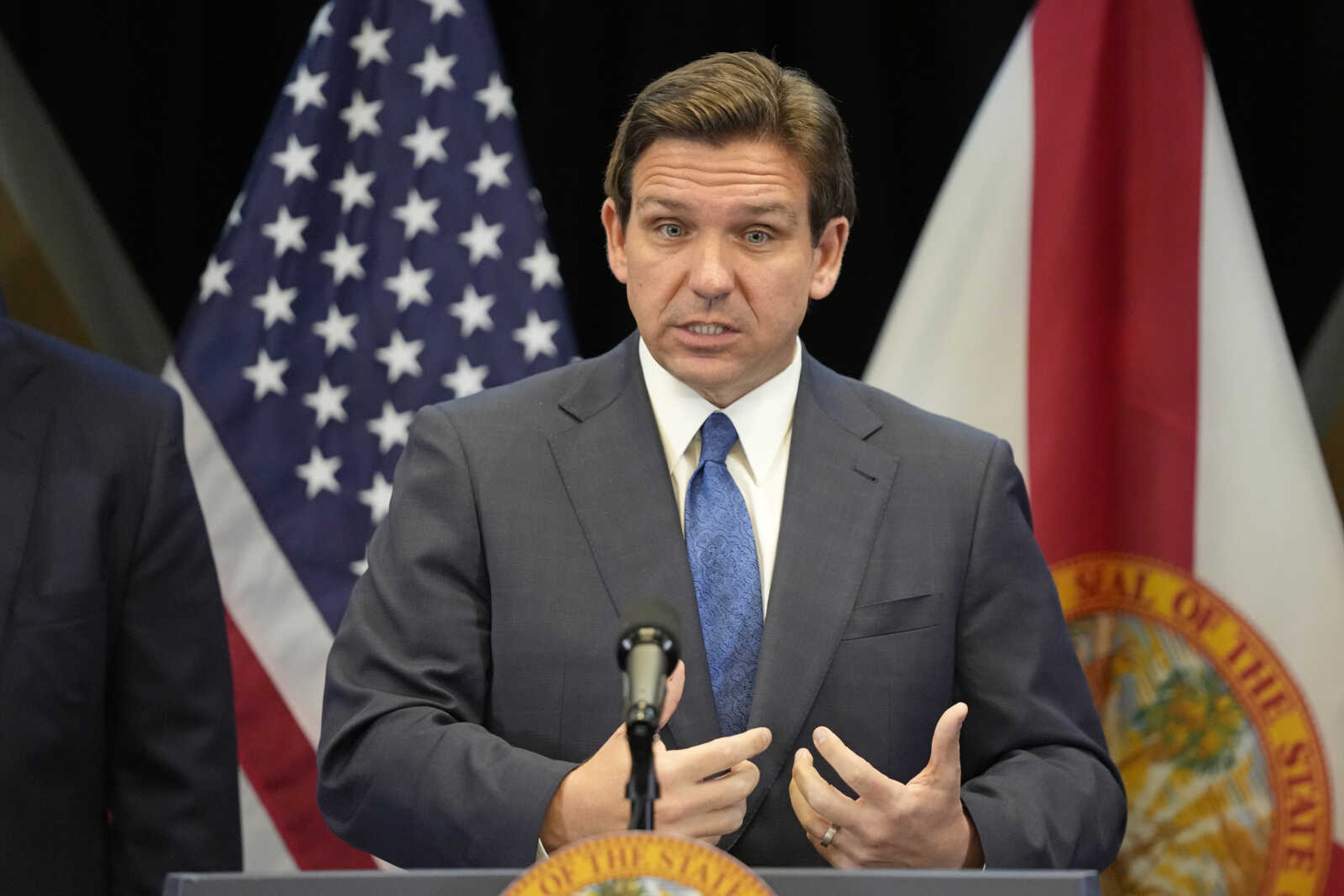 Florida Gov. Ron DeSantis speaks at a news conference Monday in Lake Buena Vista, Florida. DeSantis, who is not yet a candidate in the Republican presidential primary, has $85.8 million left over from his 2022 gubernatorial reelection campaign. But under federal law, he is prohibited from transferring that money from his state campaign to a presidential campaign committee.