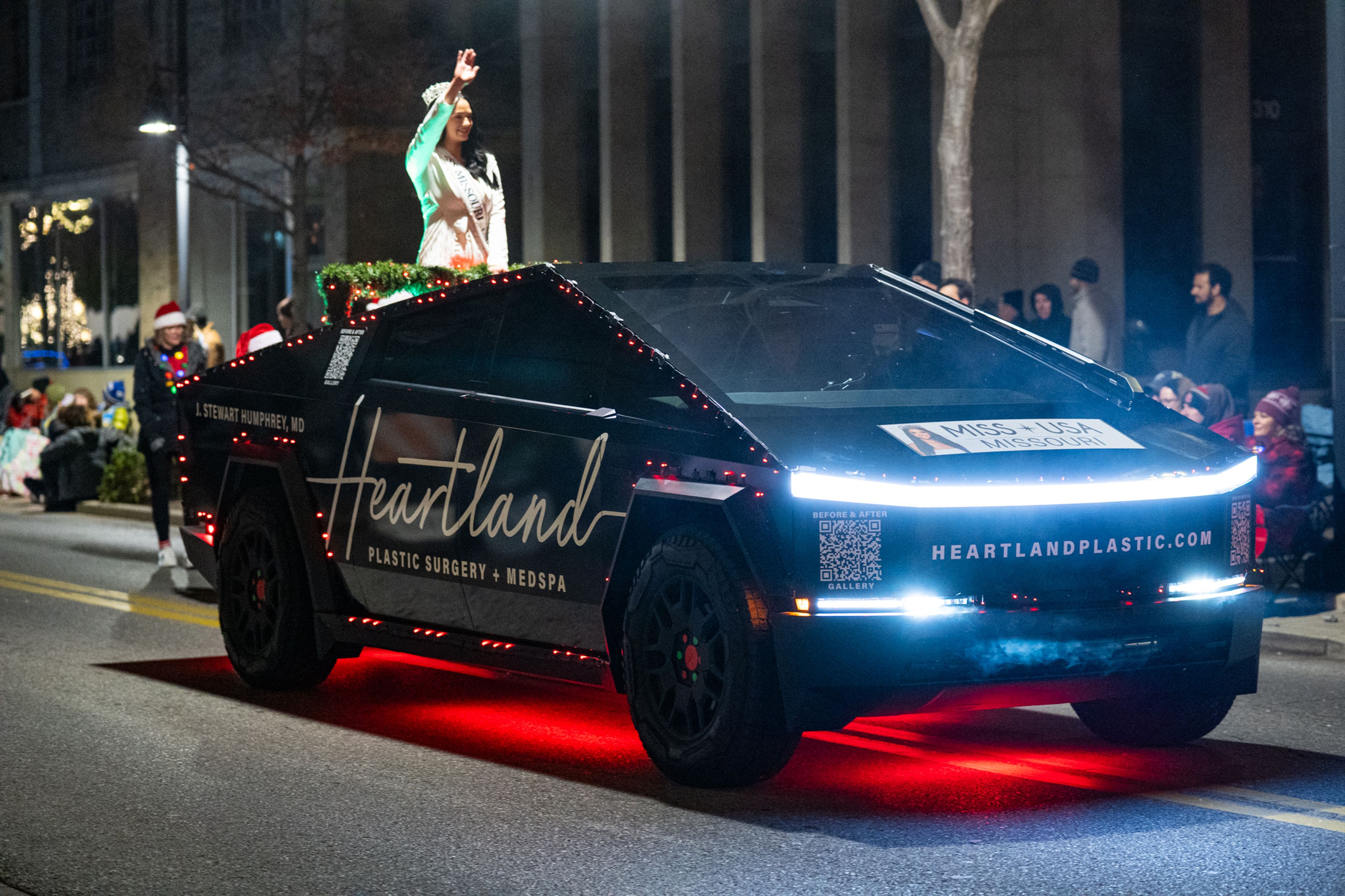 Miss Missouri USA waves from the top of a Tesla Cybertruck on Sunday, Dec. 1 at the Parade of Lights.