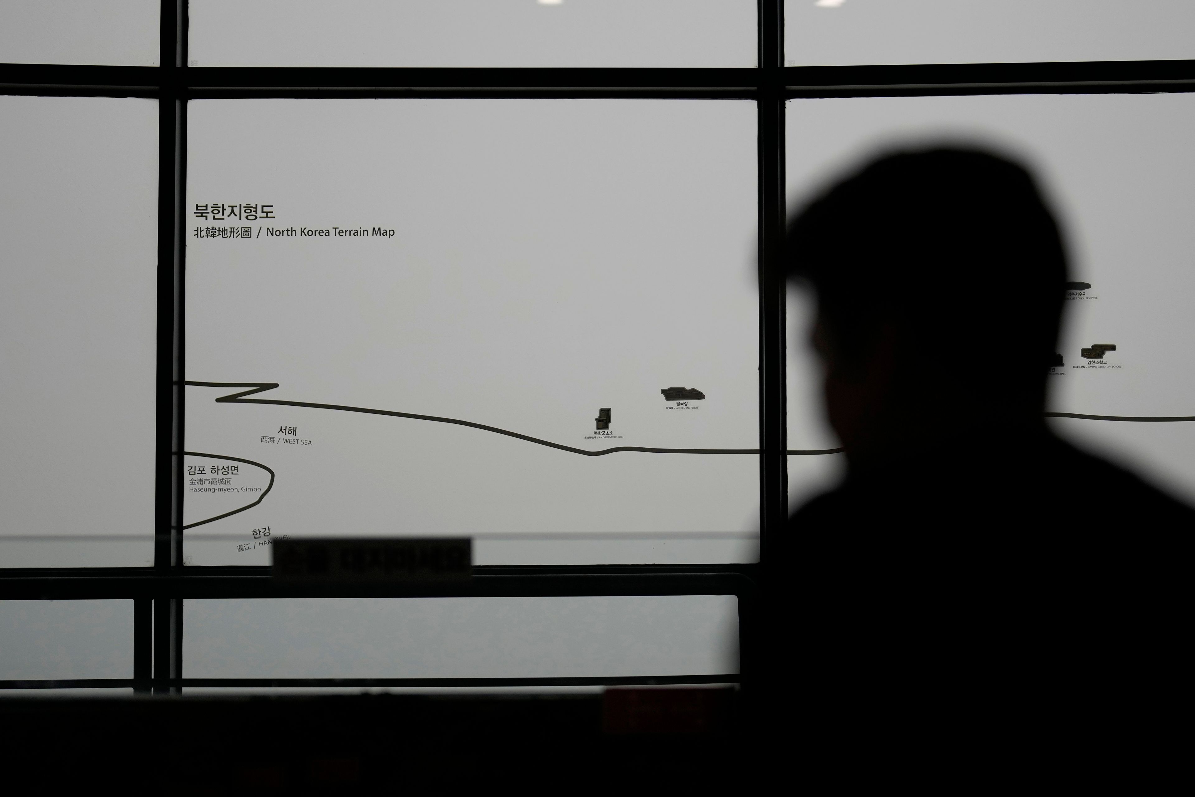 A visitor stands near a map of North Korea, in Paju, South Korea, Thursday, Sept. 5, 2024. (AP Photo/Lee Jin-man)