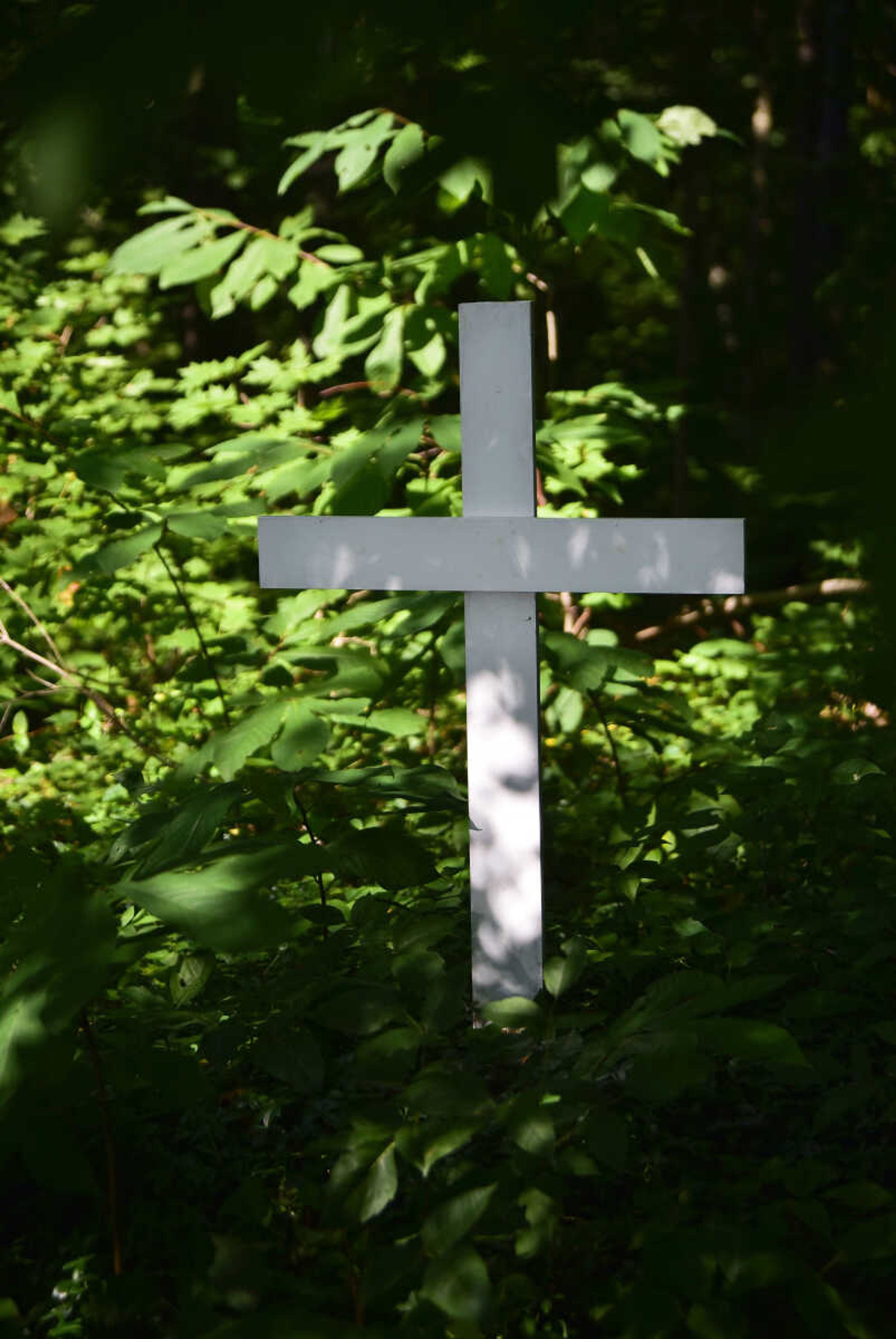 A white cross is seen at Shady Grove Cemetery Friday, July 21, 2017 in Dutchtown