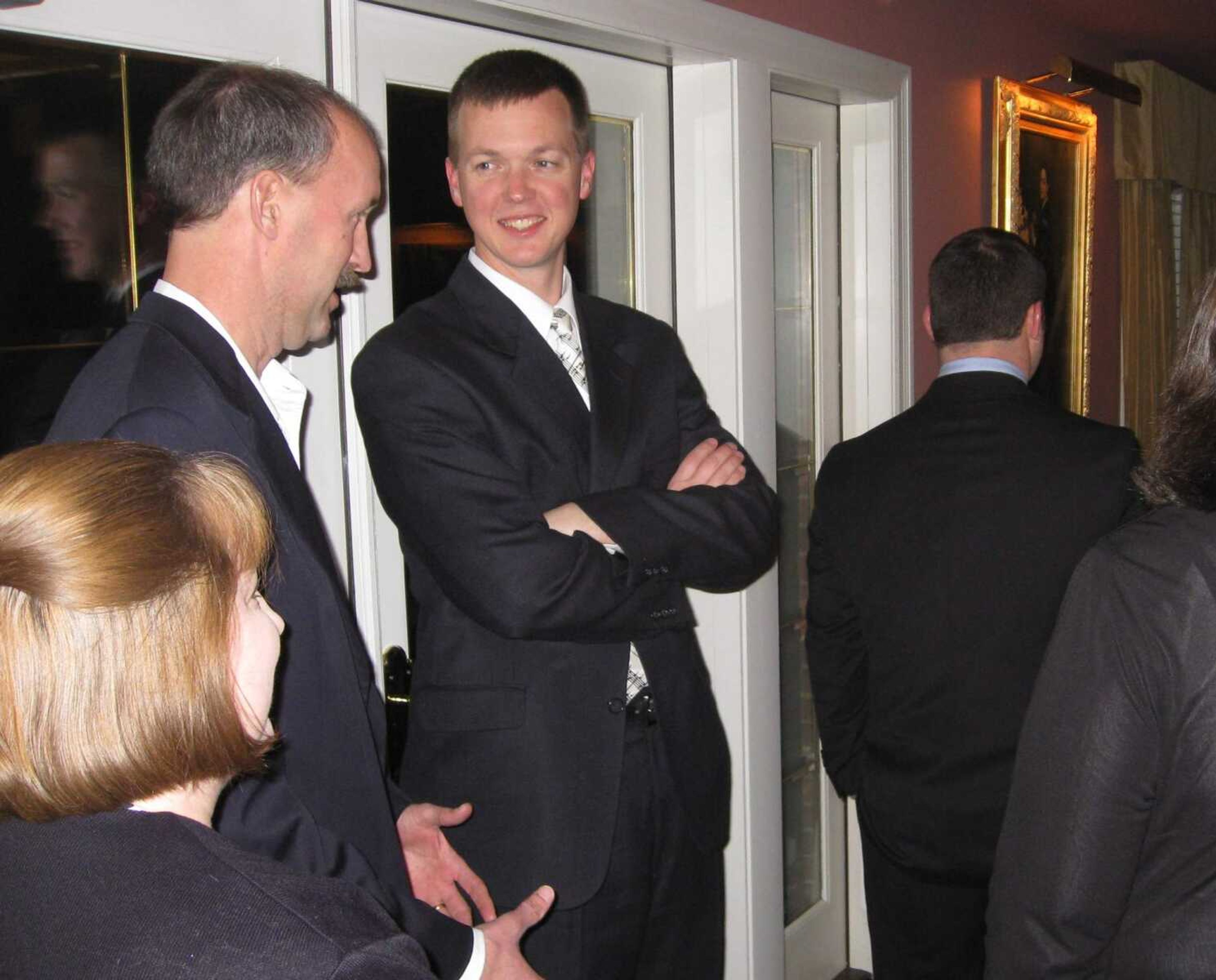 Cape Girardeau city councilman Charles J. Herbst talks with Brett Hendrickson at the Cape Girardeau Country Club during the Cape Girardeau Public School Foundation fundraiser, the Penguin Party.