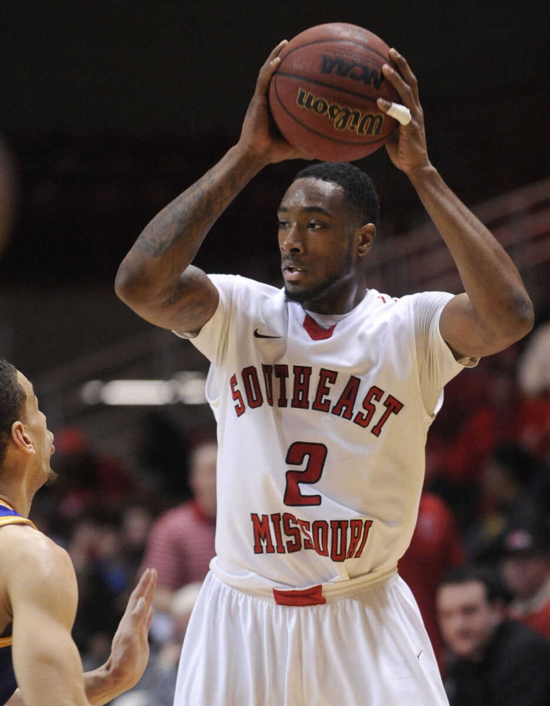 Paul McRoberts looks to pass against Missouri-Kansas City's Nelson Kirksey during a 2014 game at the Show Me Center. (Fred Lynch)