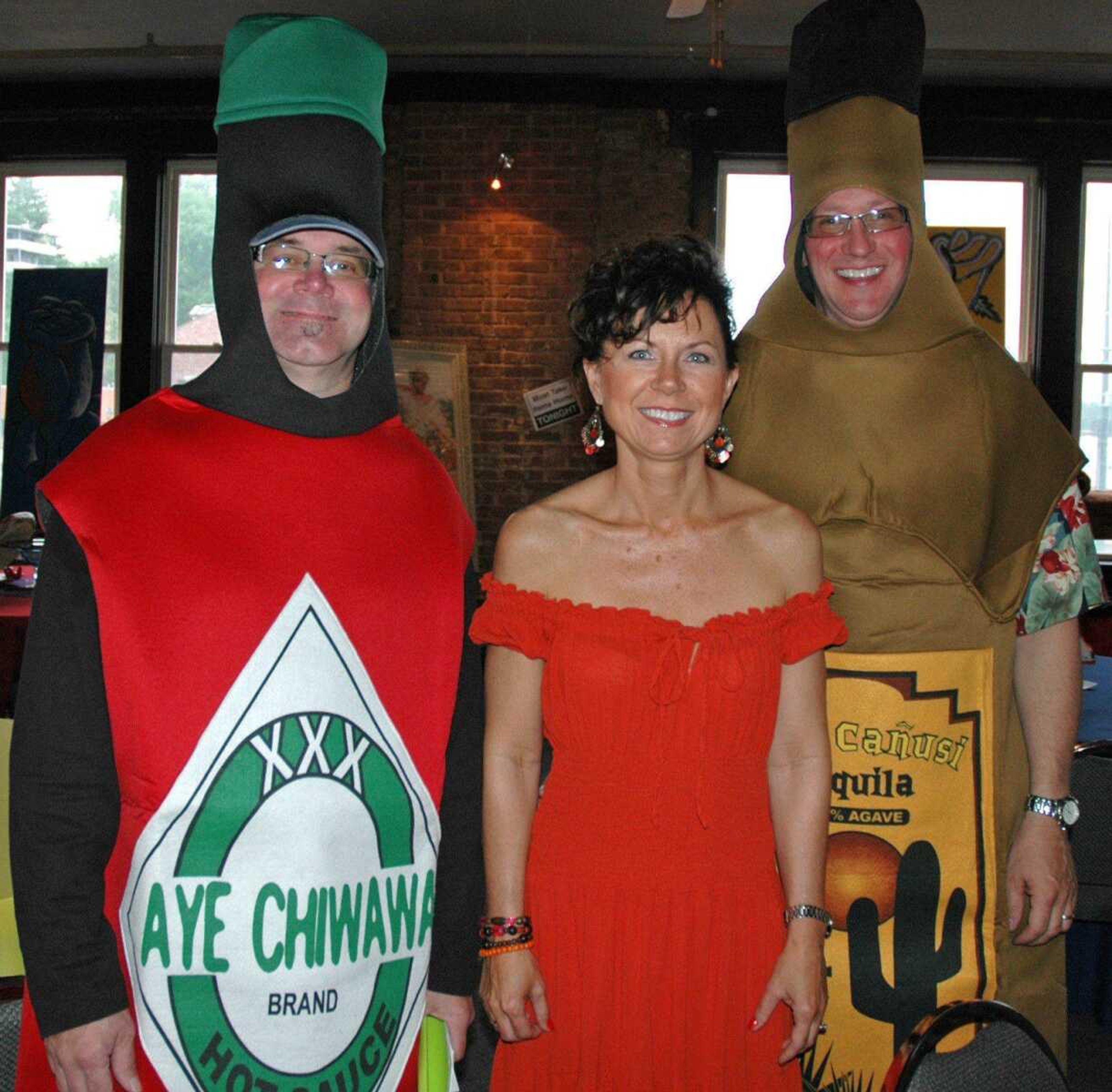 From left, Dave Hutson, Jerra Hutson and Chris Hutson attend the Charles L. Hutson Auction benefiting Old Town Cape at Buckner Brewing on May 2, 2010, in downtown Cape Girardeau.