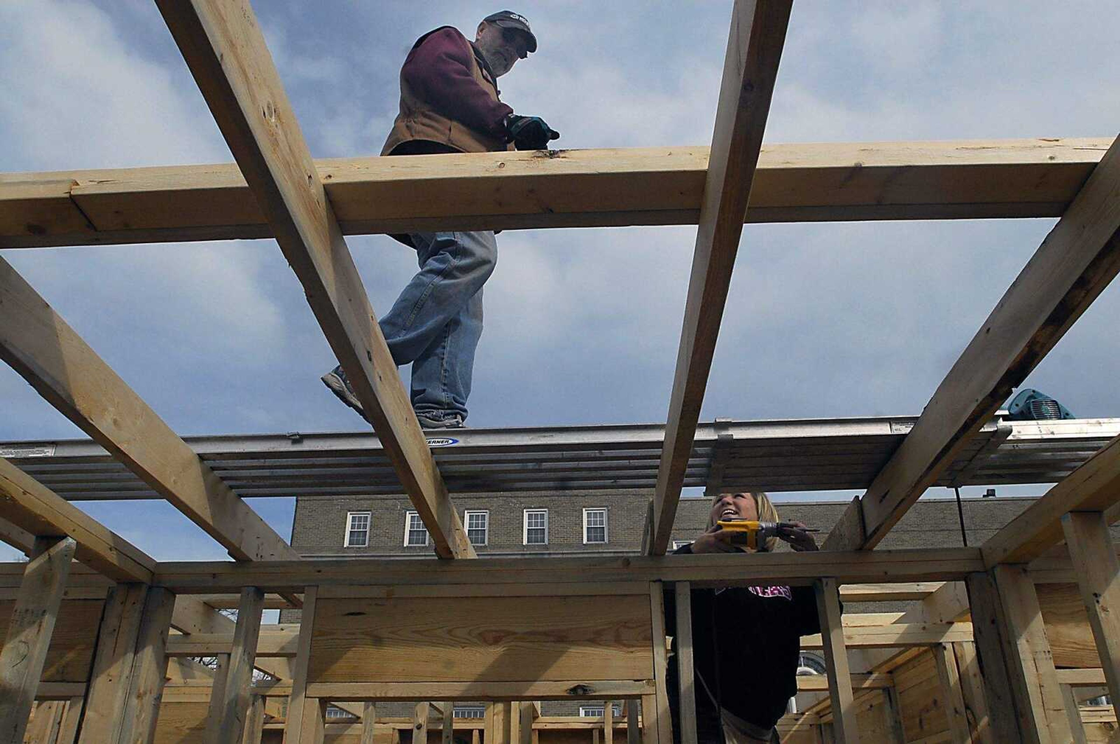 KIT DOYLE ~ kdoyle@semissourian.com
Terry Juden, left, and Amy Pinter talk at the Habitat for Humanity home being built in the Alumni Center parking lot Wednesday, March 11, 2009, in Cape Girardeau.