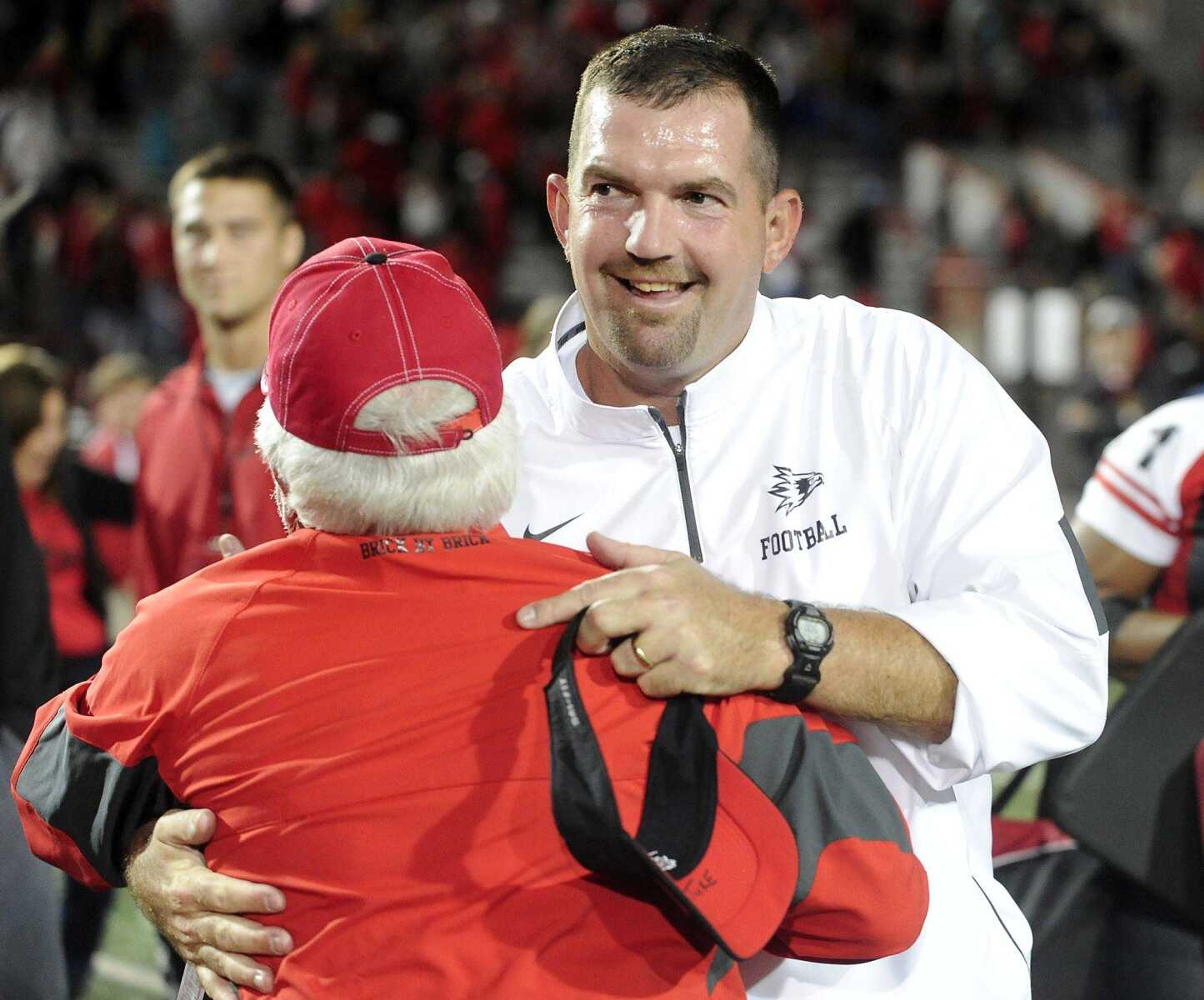 Southeast Missouri State coach Tom Matukewicz is congratulated by Bill Gosche after the Redhawks  27-24 victory over Southern Illinois Saturday night, Sept. 12, 2015 at Houck Stadium. (Fred Lynch)