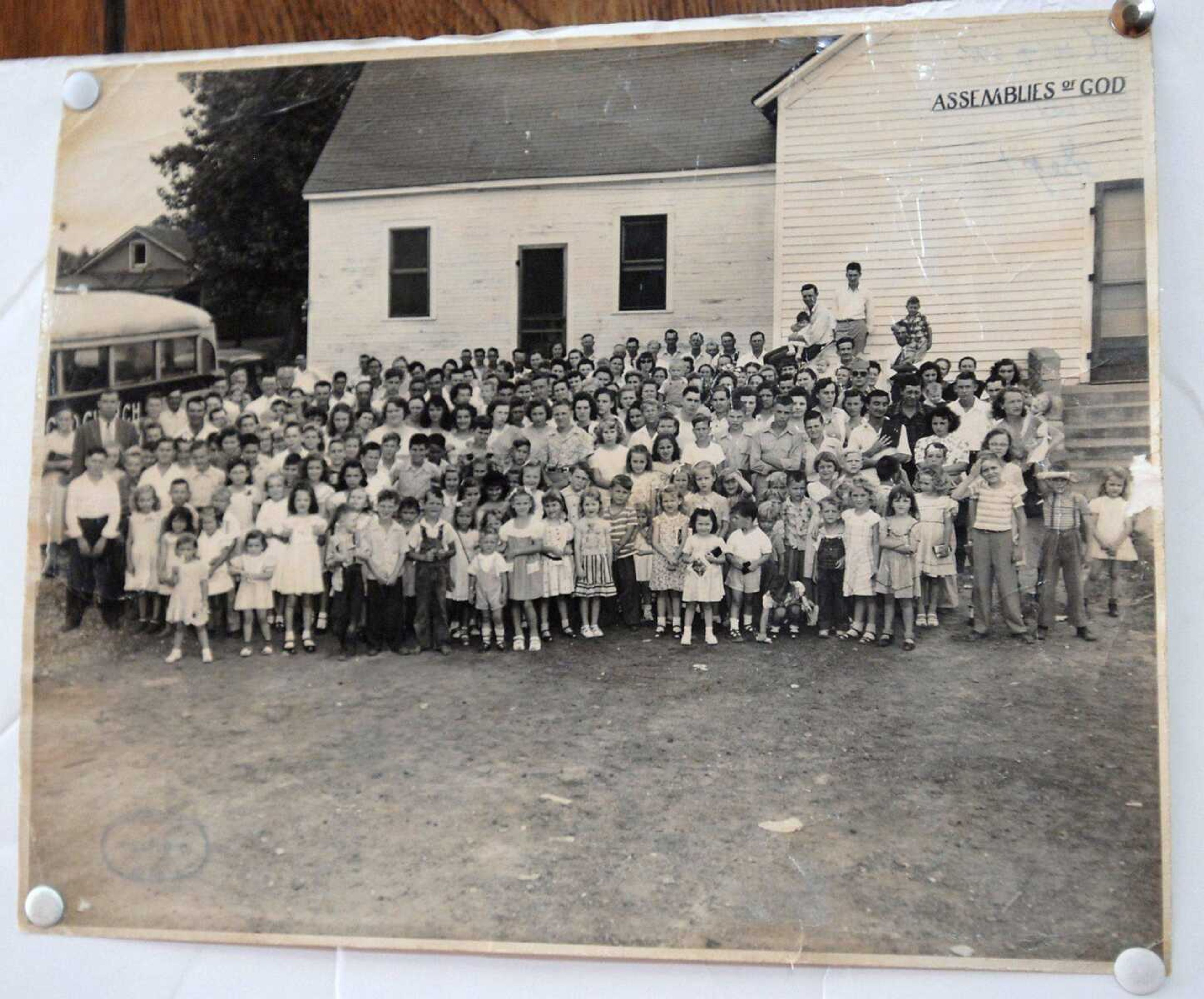 An old photo of the congregation and the church building prior to renovations is displayed at Trinity Assembly of God in Olive Branch, Ill.