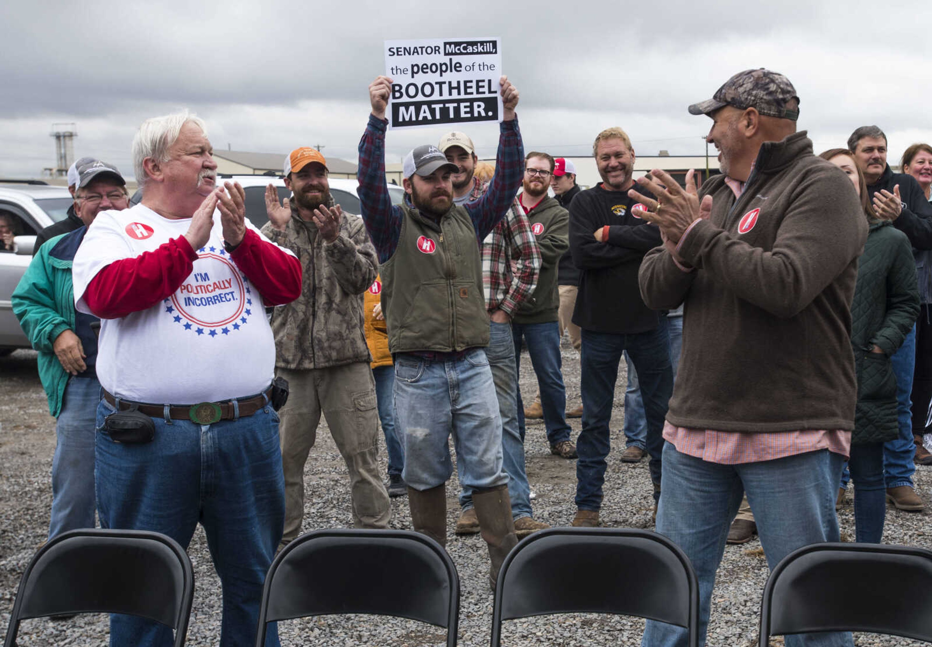 A supporter raises a campaign sign for Missouri Republican candidate Josh Hawley to see at a campaign rally Friday, Oct. 26, 2018, in Scott City.