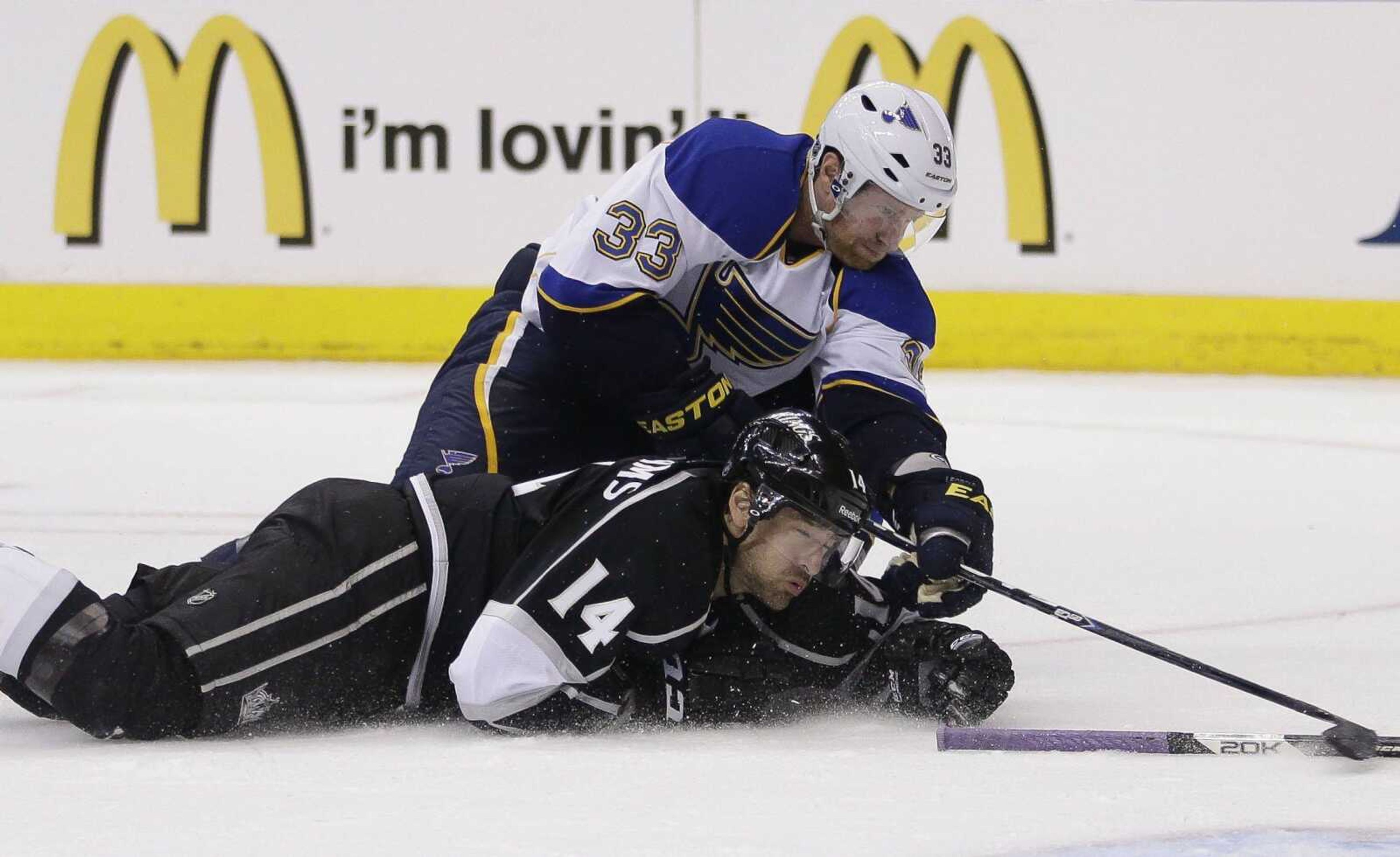 The Blues&#8217; Jordan Leopold, top, tries to shoot over the Kings&#8217; Justin Williams during the third period of Game 3 of their first-round NHL playoff series Saturday in Los Angeles. The Kings won 1-0. (Jae C. Hong ~ Associated Press)