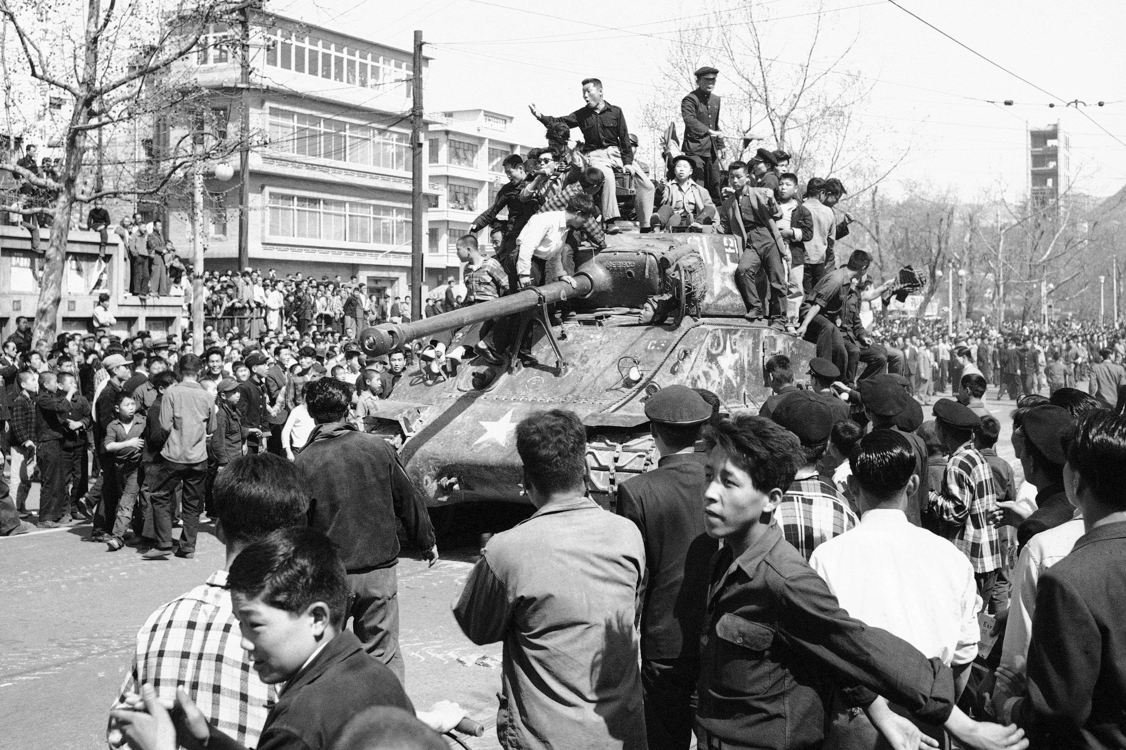 FILE- Jubilant South Koreans surmounted an army tank in Seoul's City Hall Plaza on April 27, 1960 as they celebrated apparent victory over President Syngman Rhee's government. Rhee resigned on April 27 in the face of nationwide demonstrations for democratic reforms and new elections. (AP Photo/File)