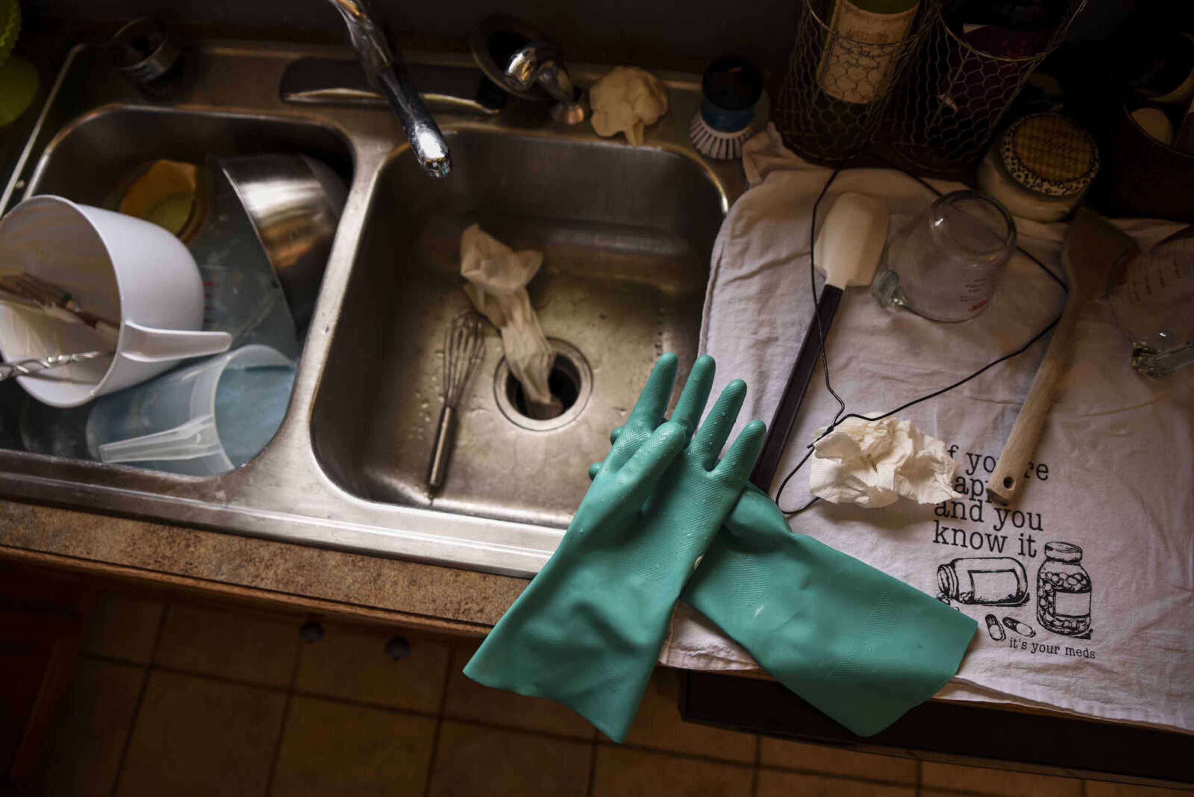 Rubber gloves and other soap-making items sit in the kitchen sink after Breanna Stone made her homemade soap in her home Tuesday, May 1, 2018, in Jackson.