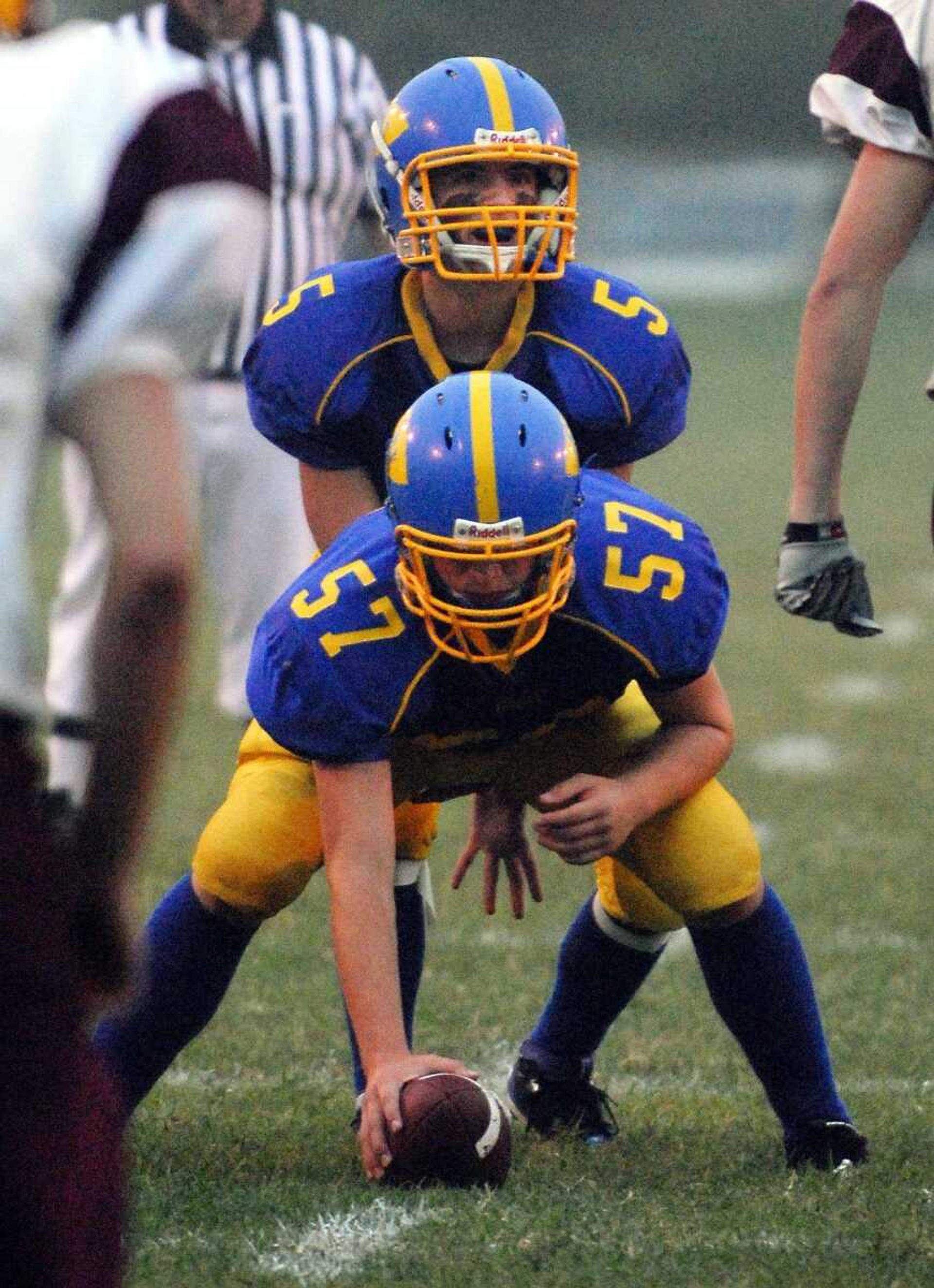 St. Vincent's Taylor Sauer(57) hands off the ball to teammate Tim Schummer(5) Friday, September 10, 2010 during their home game against Missouri Military. (Laura Simon)