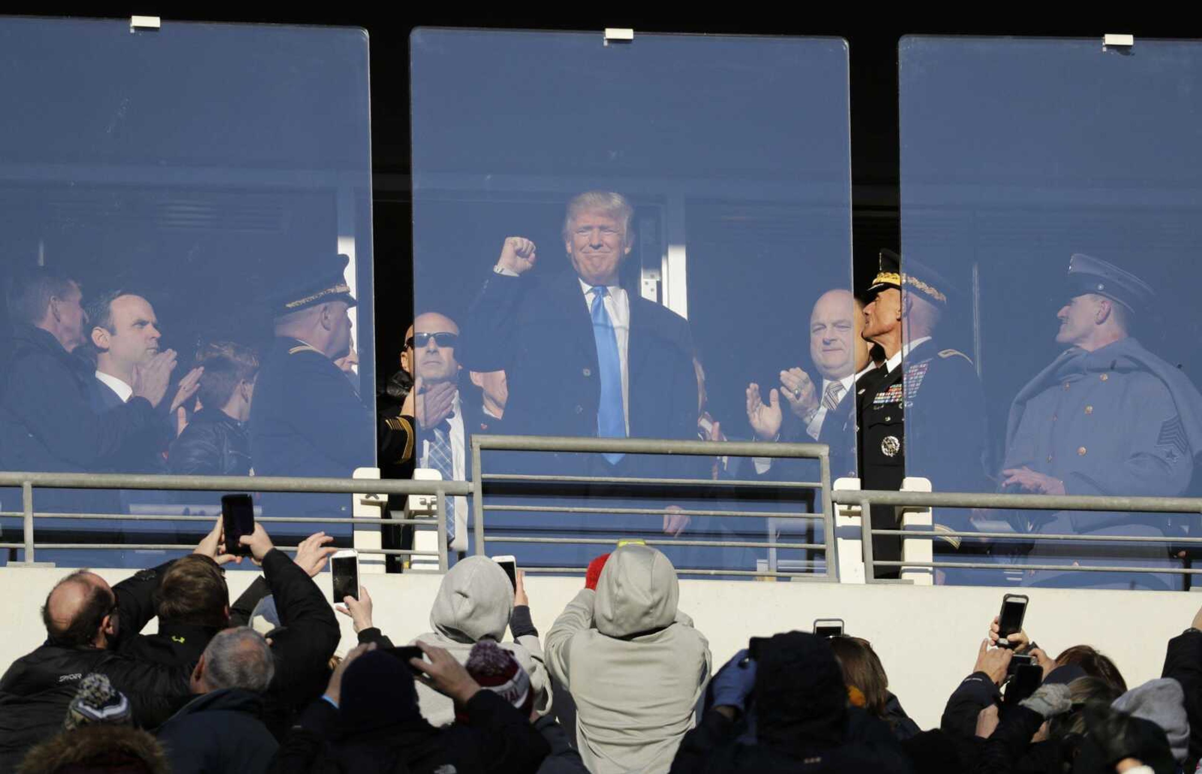 President-elect Donald Trump acknowledges spectators Saturday during the first half of the Army-Navy NCAA college football game in Baltimore.