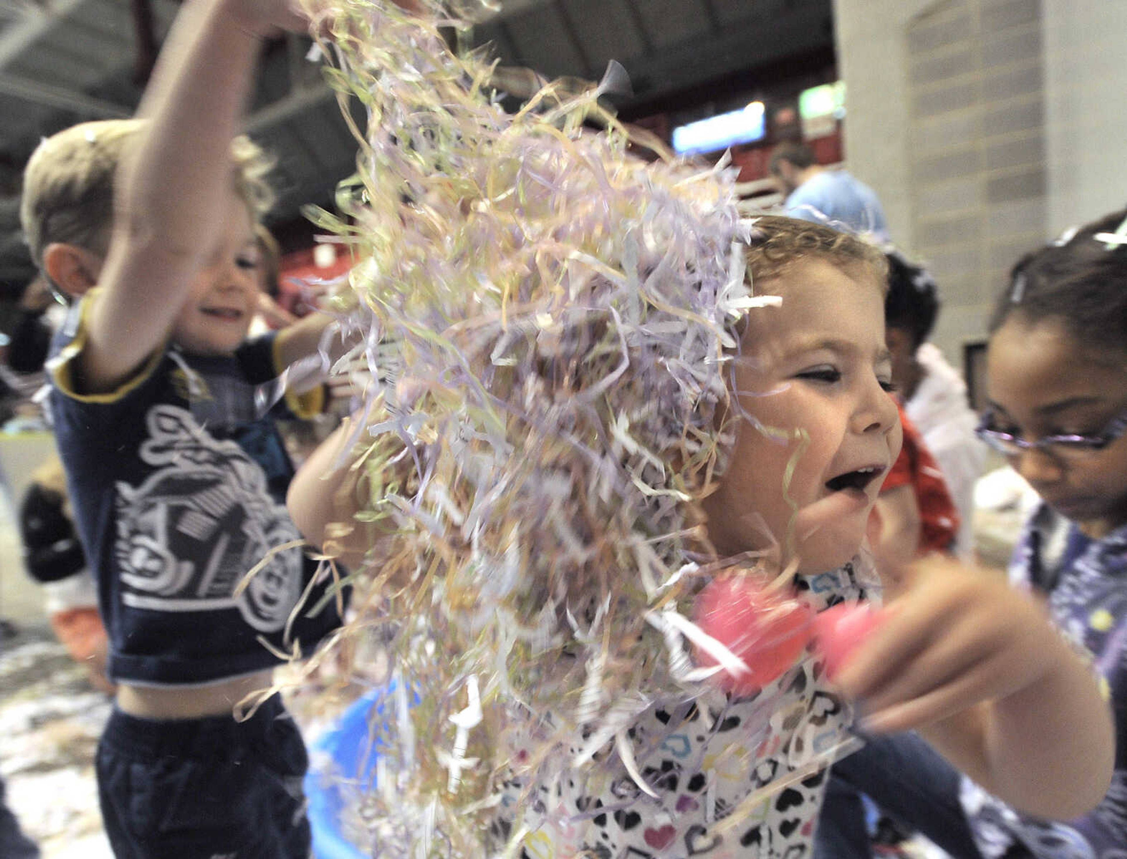 FRED LYNCH ~ flynch@semissourian.com
Cosette Statler playfully runs from her brother, Preston Statler, both of Cape Girardeau, as they play with shredded paper at the Messy Morning event, which celebrates the Week of the Young Child, Saturday, April 25, 2015 at the Show Me Center.