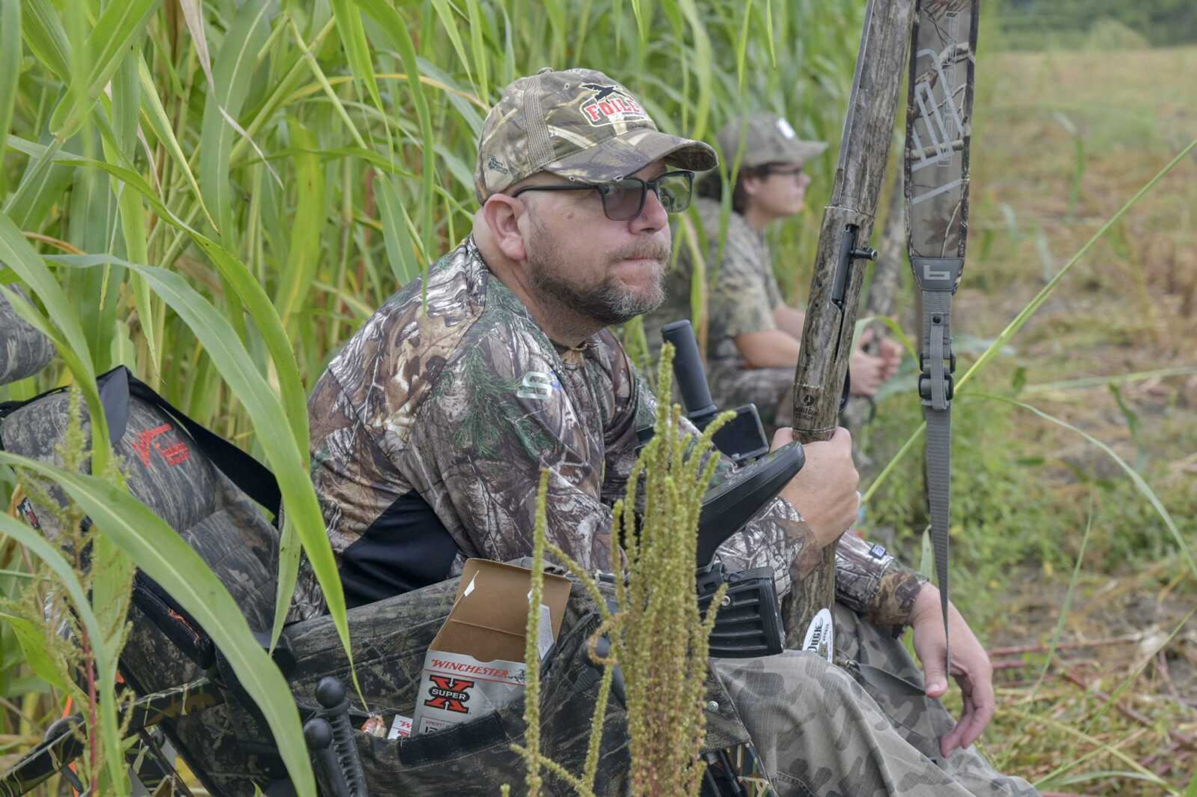 Eston Livingston and his son Weston Livingston sit near the edge of tall grass while on the lookout for doves during MDC's Mobility Impaired Dove Hunt at the Ten Mile Pond in East Prairie Wednesday Sept. 1, 2021.