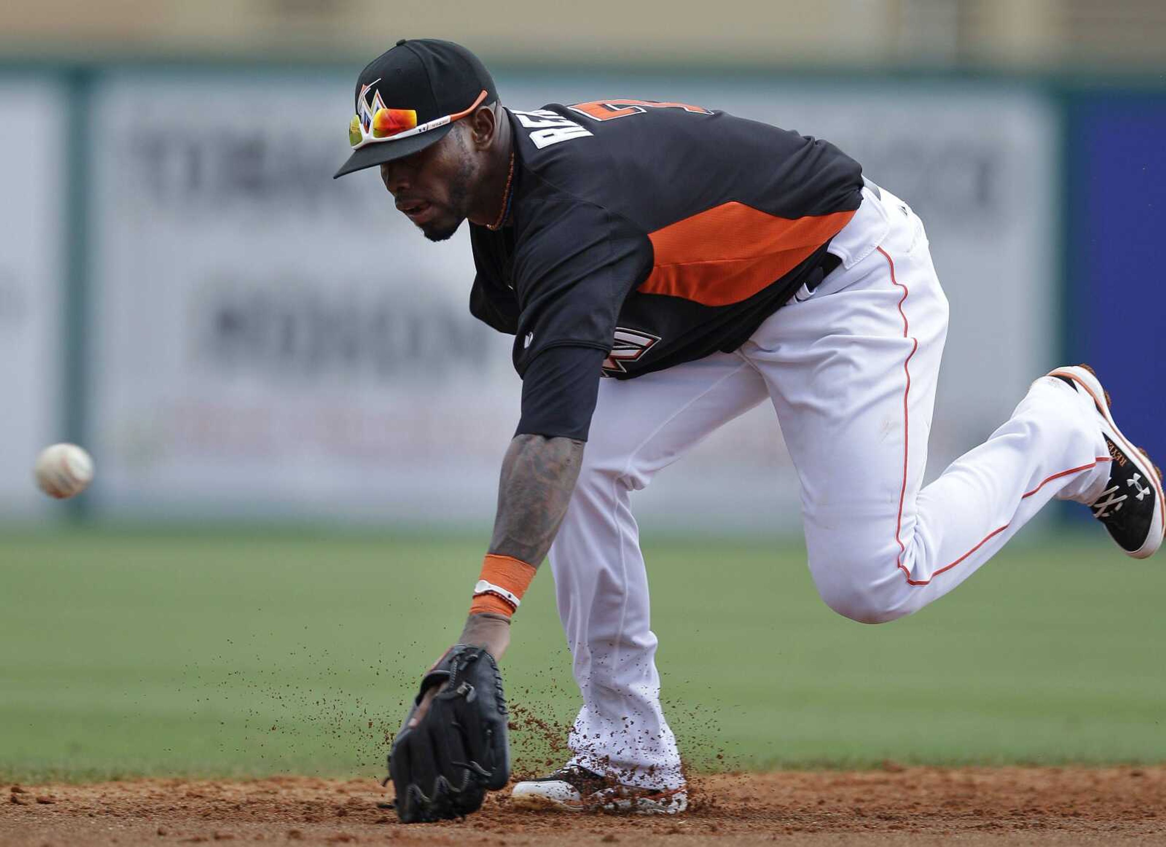 Marlins shortstop Jose Reyes misses a ground ball hit by Cardinals batter Erik Komatsu during the third inning.