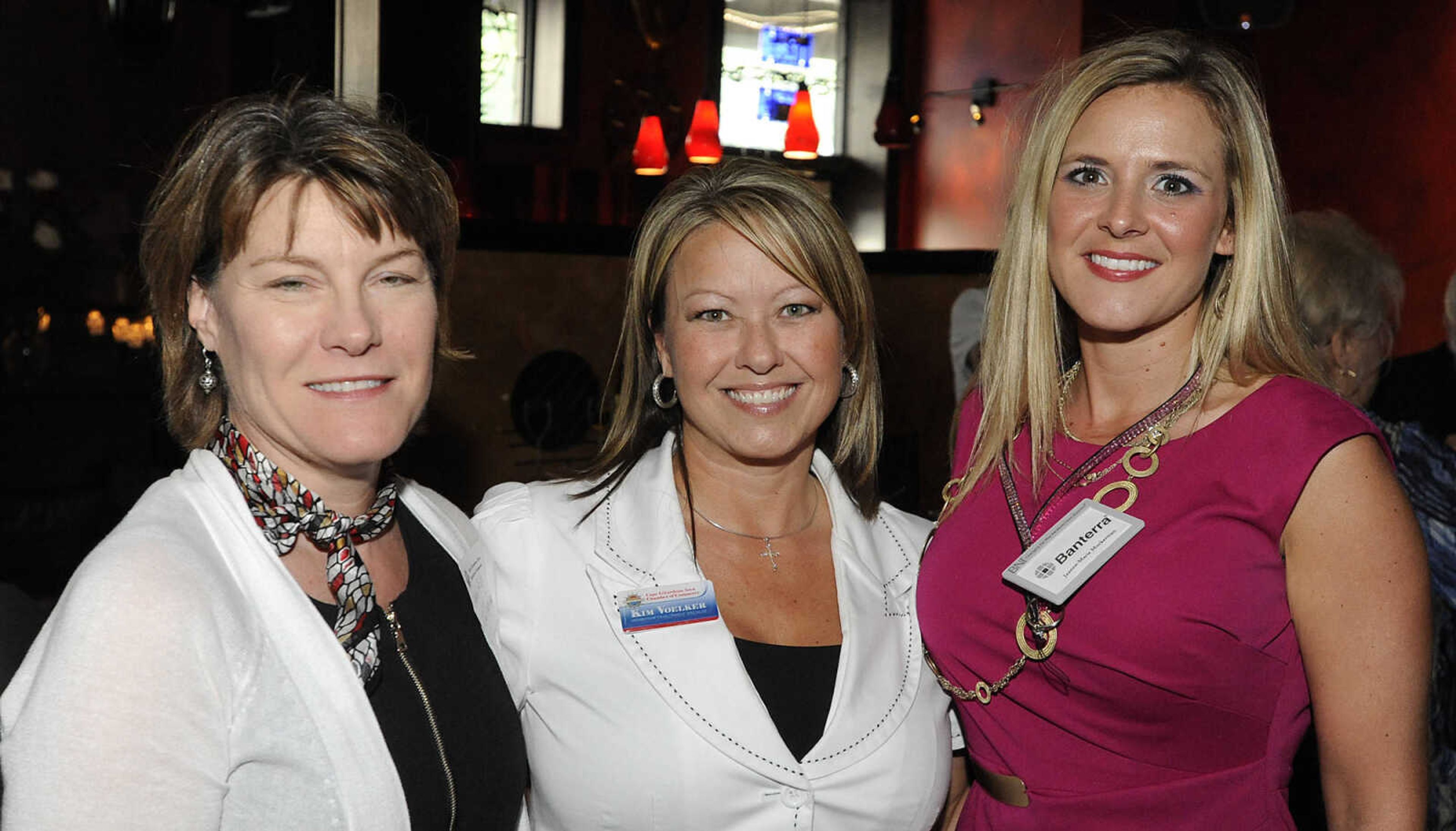 Marla Mills, of Old Town Cape, left, Kim Voelker, of the Cape Girardeau Chamber of Commerce, and Jeanne-Marie Muckerman of Banterra Bank, during the Cape Girardeau Area Chamber of Commerce Business After Hours Tuesday, June 18, at The Library, 10 South Spanish St., in Cape Girardeau.