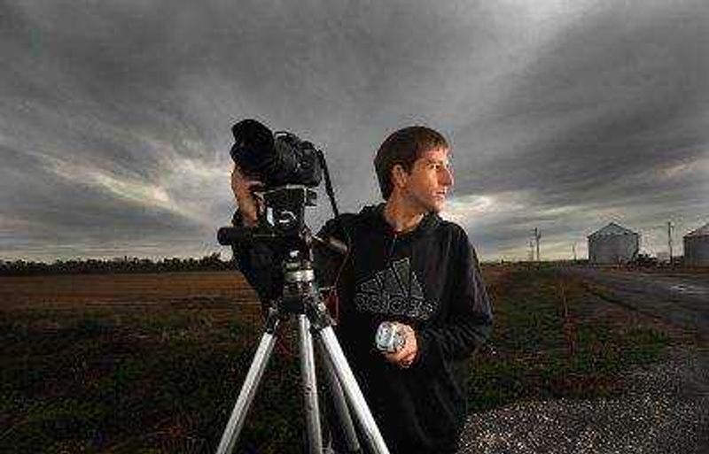 LAURA SIMON ~ lsimon@semissourian.com 
  
 David Patterson stands with his camera and weather radio in hand at one of his favorite weather watching spots in Southern Illinois, Tuesday, Oct. 28, 2014.