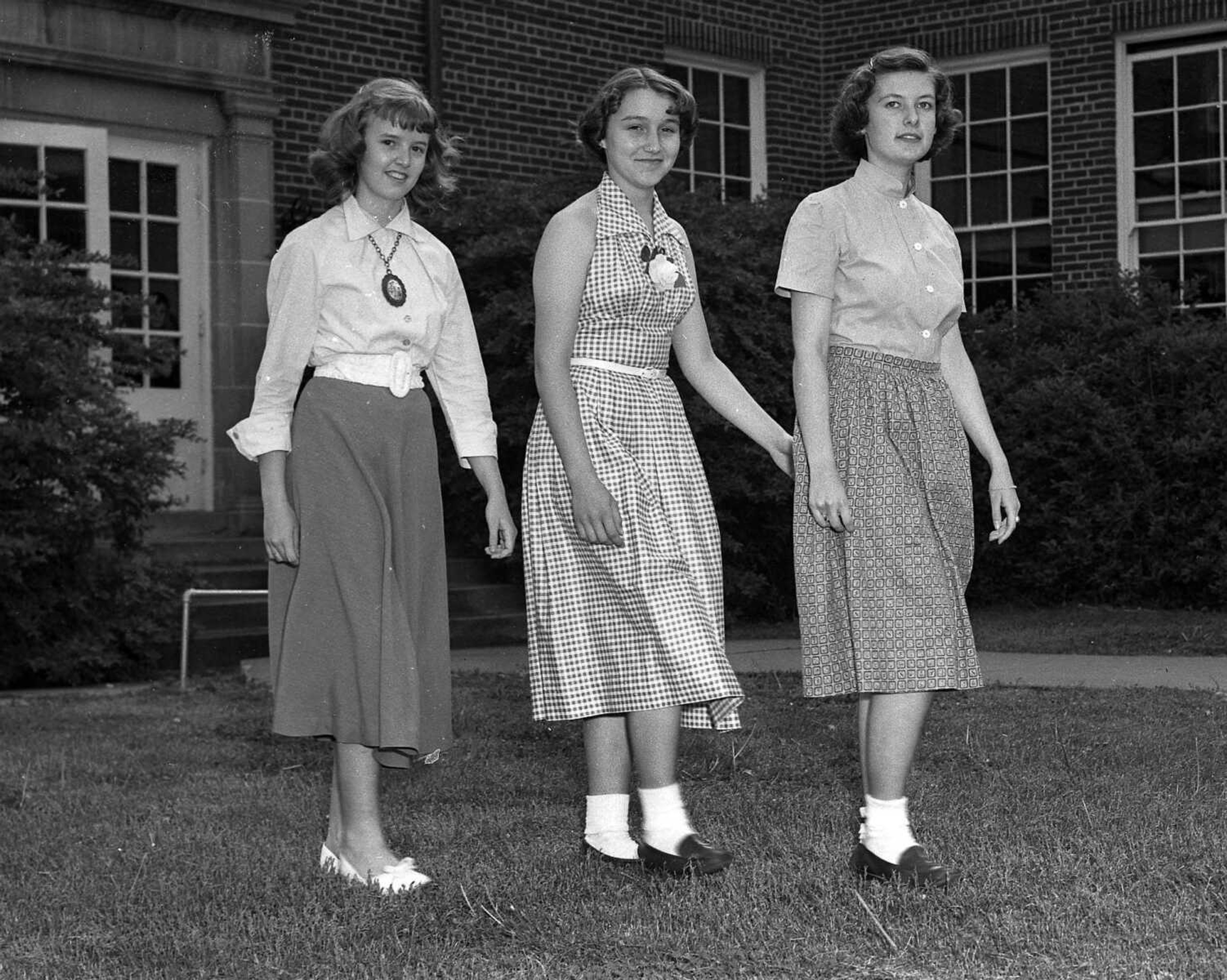 May 13, 1953 Southeast Missourian.
Teenage models of Franklin School pose in their new summertime clothes they made in home economics class this year. The eighth grade girls modeled the garments in a fashion show for the Franklin Parent-Teacher Unit meeting last week. Here Ruth Ann Drum, left, and June Bowden, right, are wearing smart skirt and blouse ensembles, and June Fingerhut, center, sports a light check pattern sunback dress. (G.D. Fronabarger/Southeast Missourian archive)