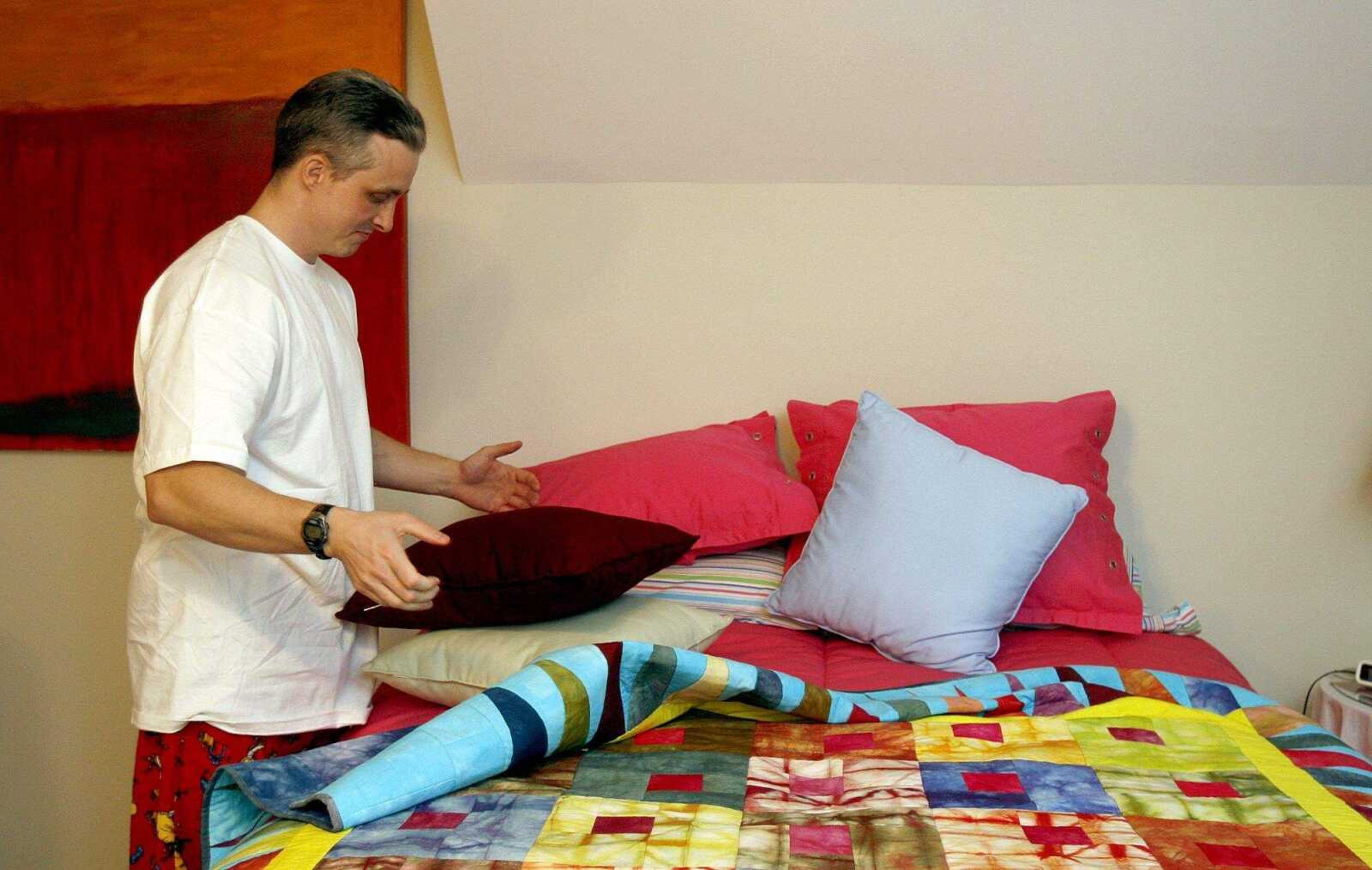 ELIZABETH DODD ~ edodd@semissourian.com
Joshua Kezer rearranges pillows and sheets before sleeping in a real bed for the first time in 15 years. "I'll probably go into a coma," Kezer said.