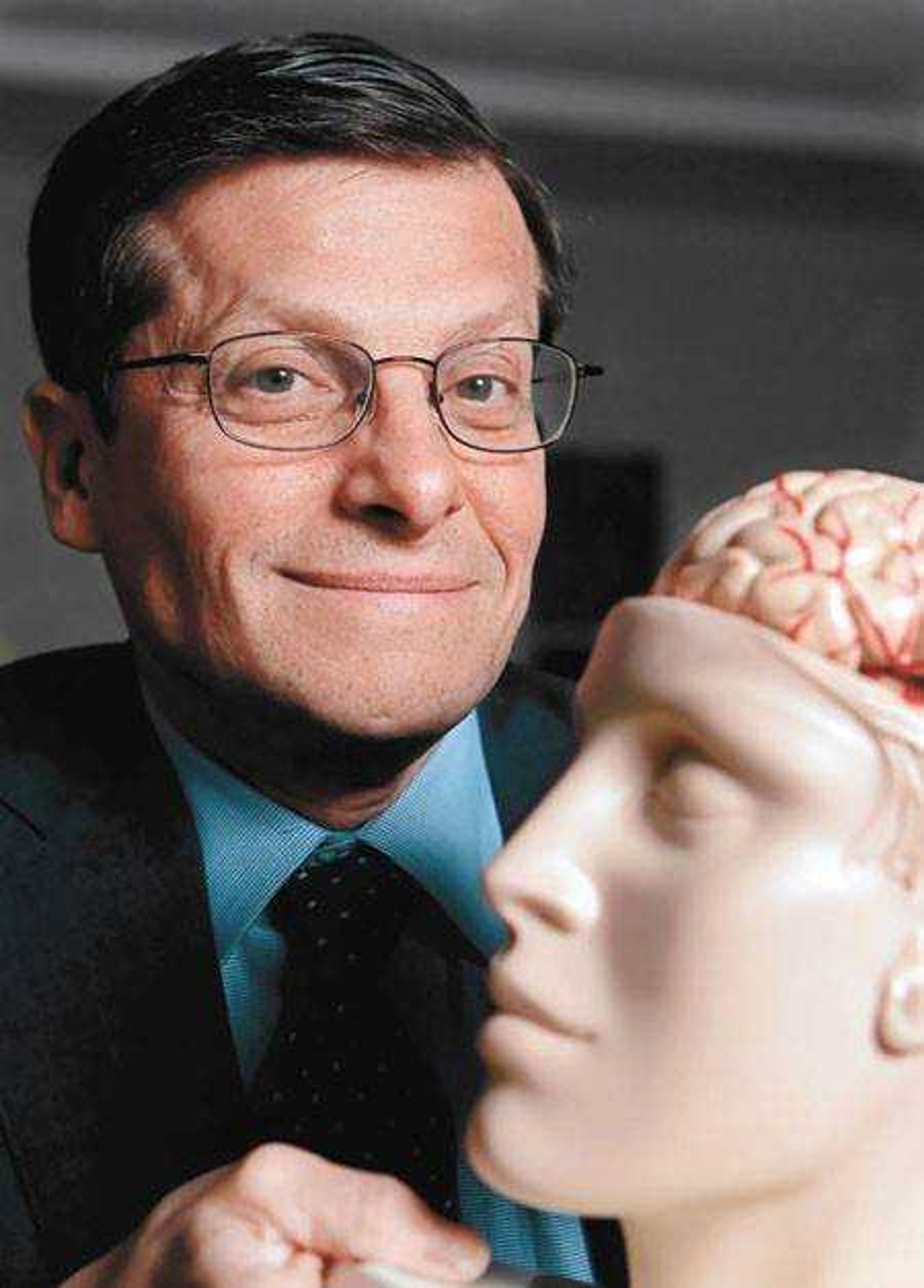 Dr. Michael Roizen held a classroom model of the human brain in his office at the Cleveland Clinic last month. Roizen and Dr. Mehmet Oz from Columbia University co-authored "You: The Owner's Manual," billed as an insider's guide to the human body. (Mark Duncan)