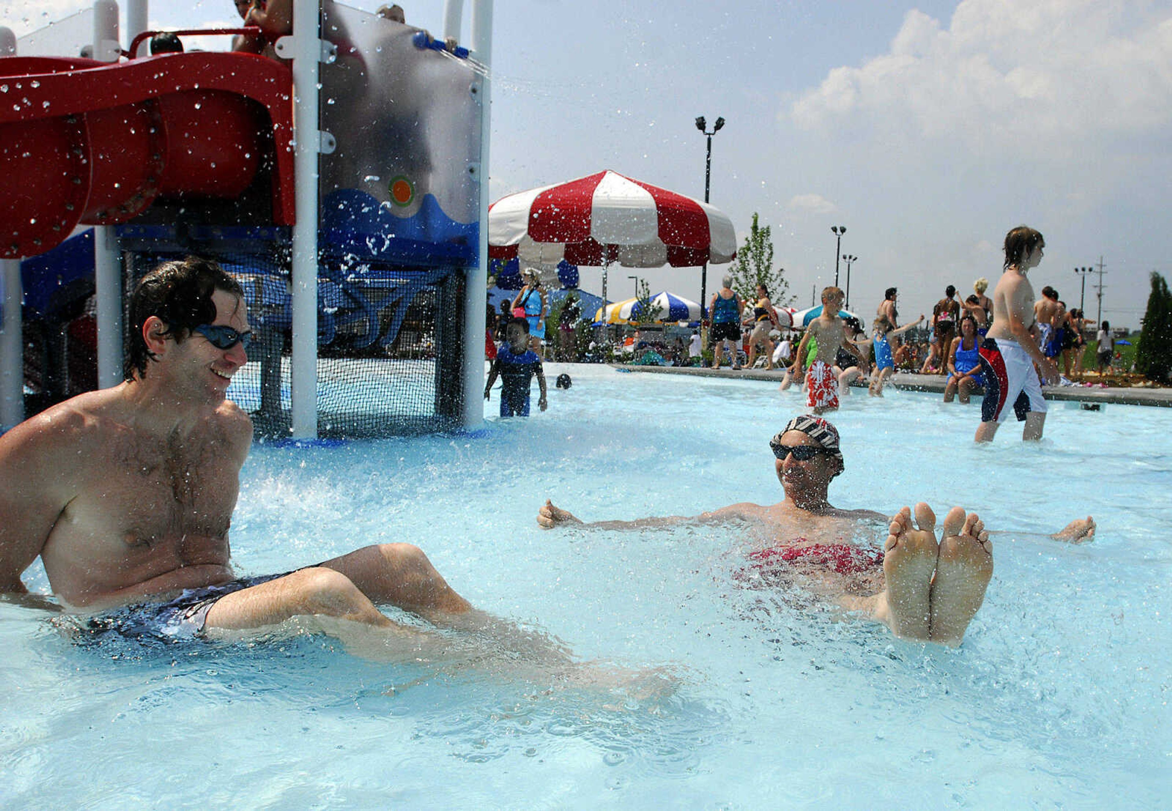 LAURA SIMON~lsimon@semissourian.com
Bryan, left, and Brad Hanebrink relax in the play pool area Saturday, May 29, 2010 during the opening day of Cape Splash Family Auquatic Center.