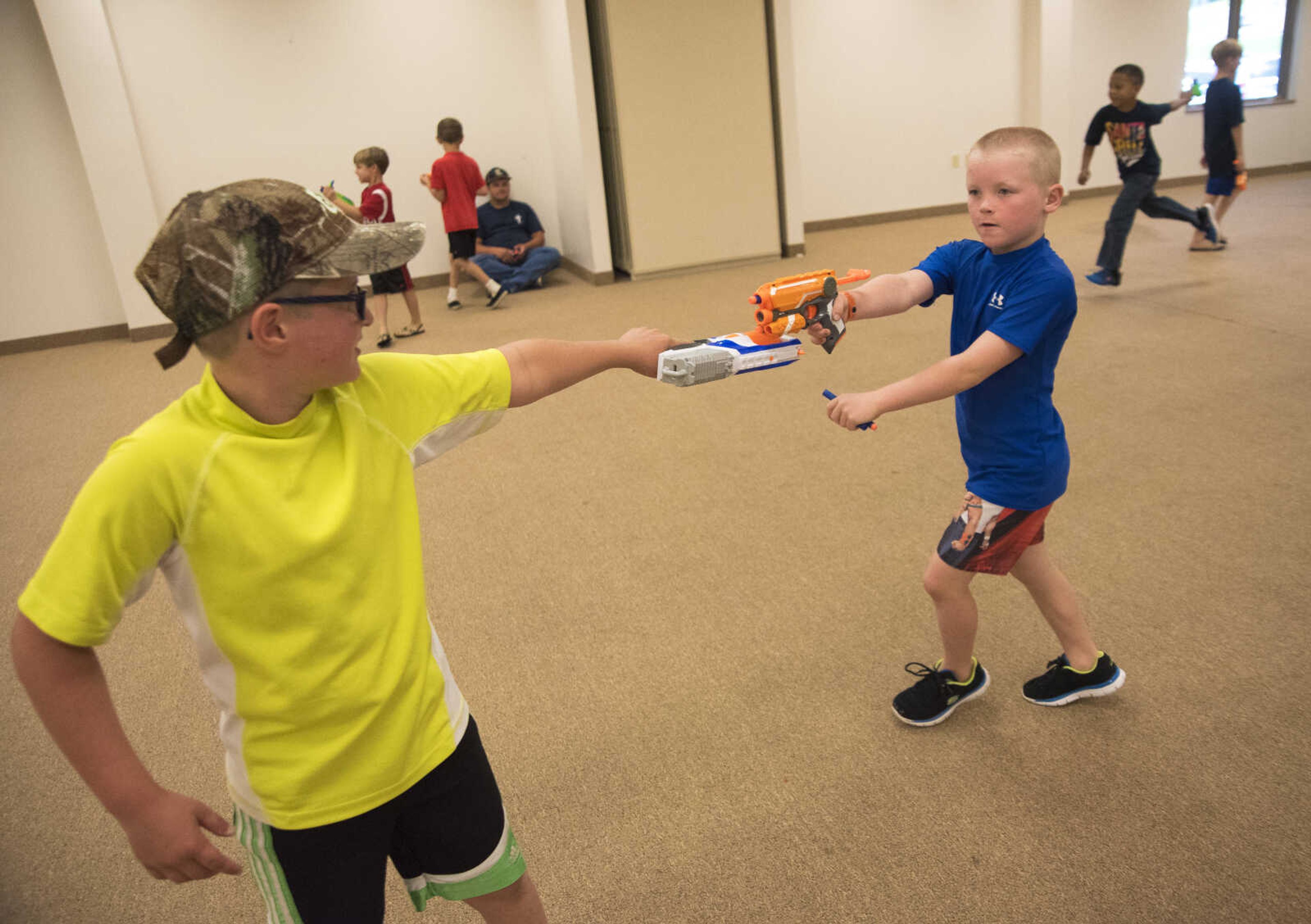 Christopher Wilfong, 10, left, and Hayden Swain, 7, right, have a nerf gun war during the Parks and Rec Day Friday, July 7, 2017 at the Osage Centre in Cape Girardeau.