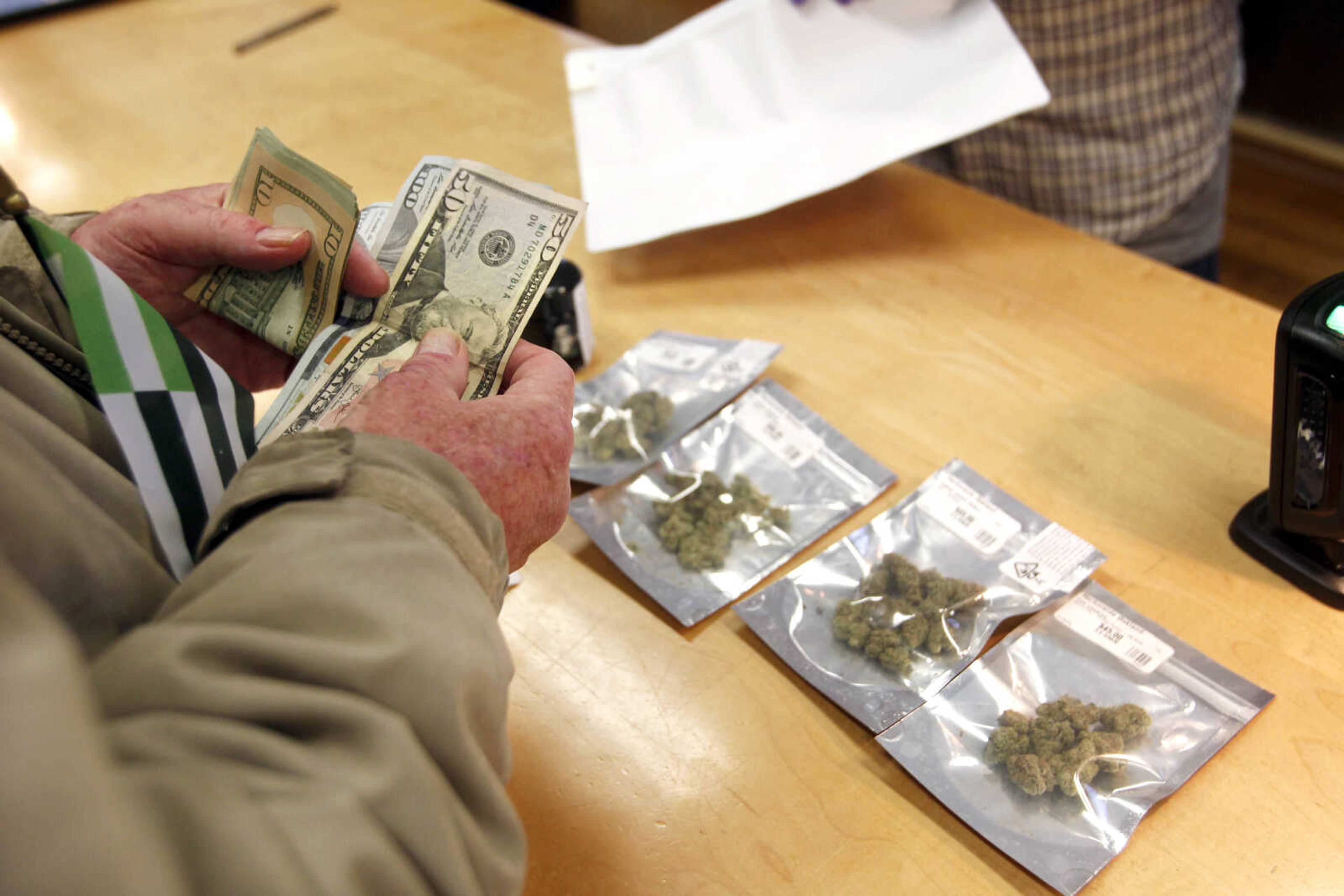 A customer purchases marijuana at Harborside marijuana dispensary Monday in Oakland, California.