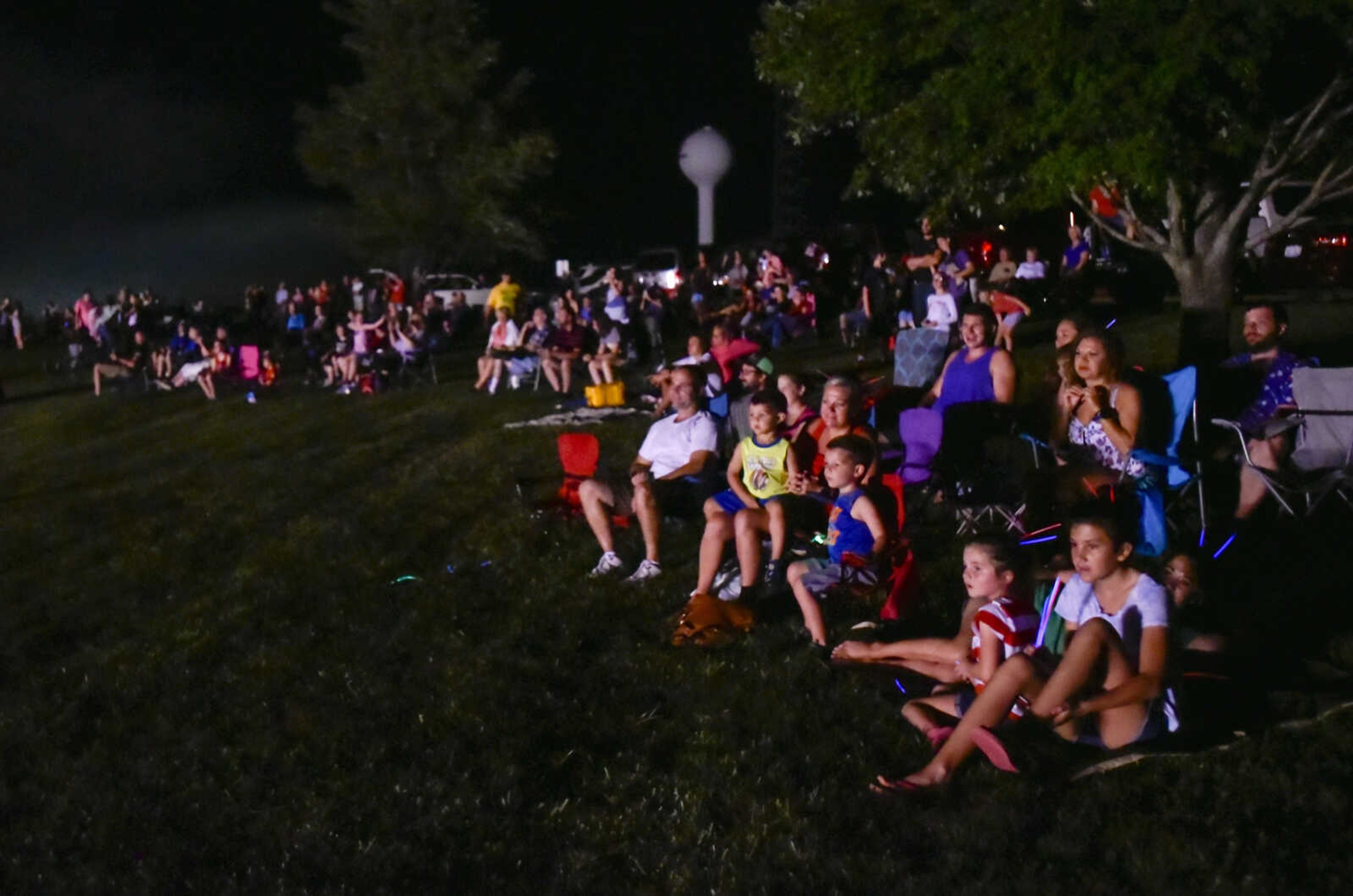 Guests sit on the Cape County Park North lawn while watching the grand finale during the Missouri Veterans Home fireworks show Tuesday, July 3, 2018, in Cape Girardeau.