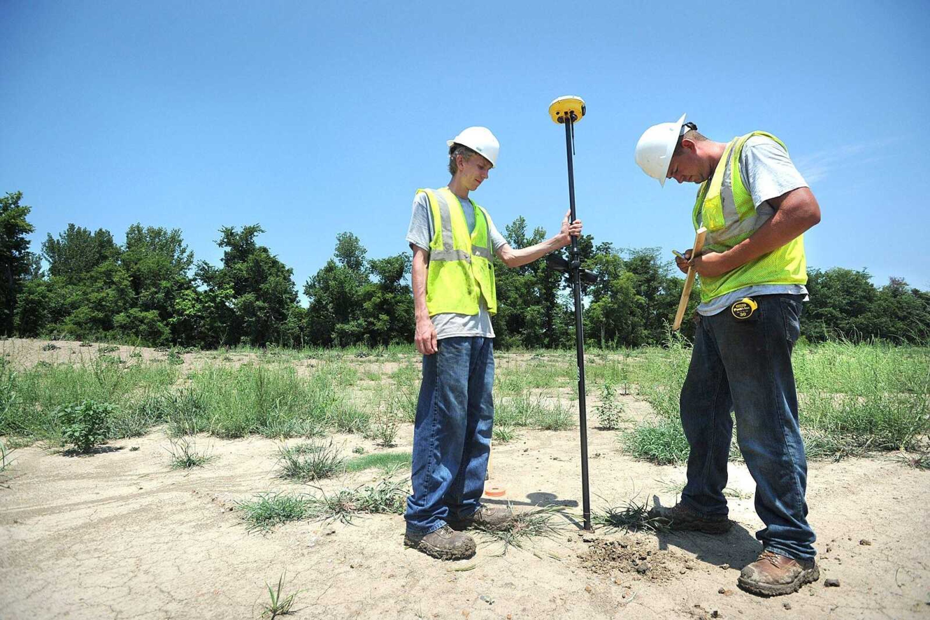 Bryan Harding, left, and his brother Josh survey the toe of the slope at the site of the intentional breach in the Birds Point Levee Thursday, July 19, 2012 in Mississippi County. The first phase of construction of the levee is expected to begin early next week. (Laura Simon)