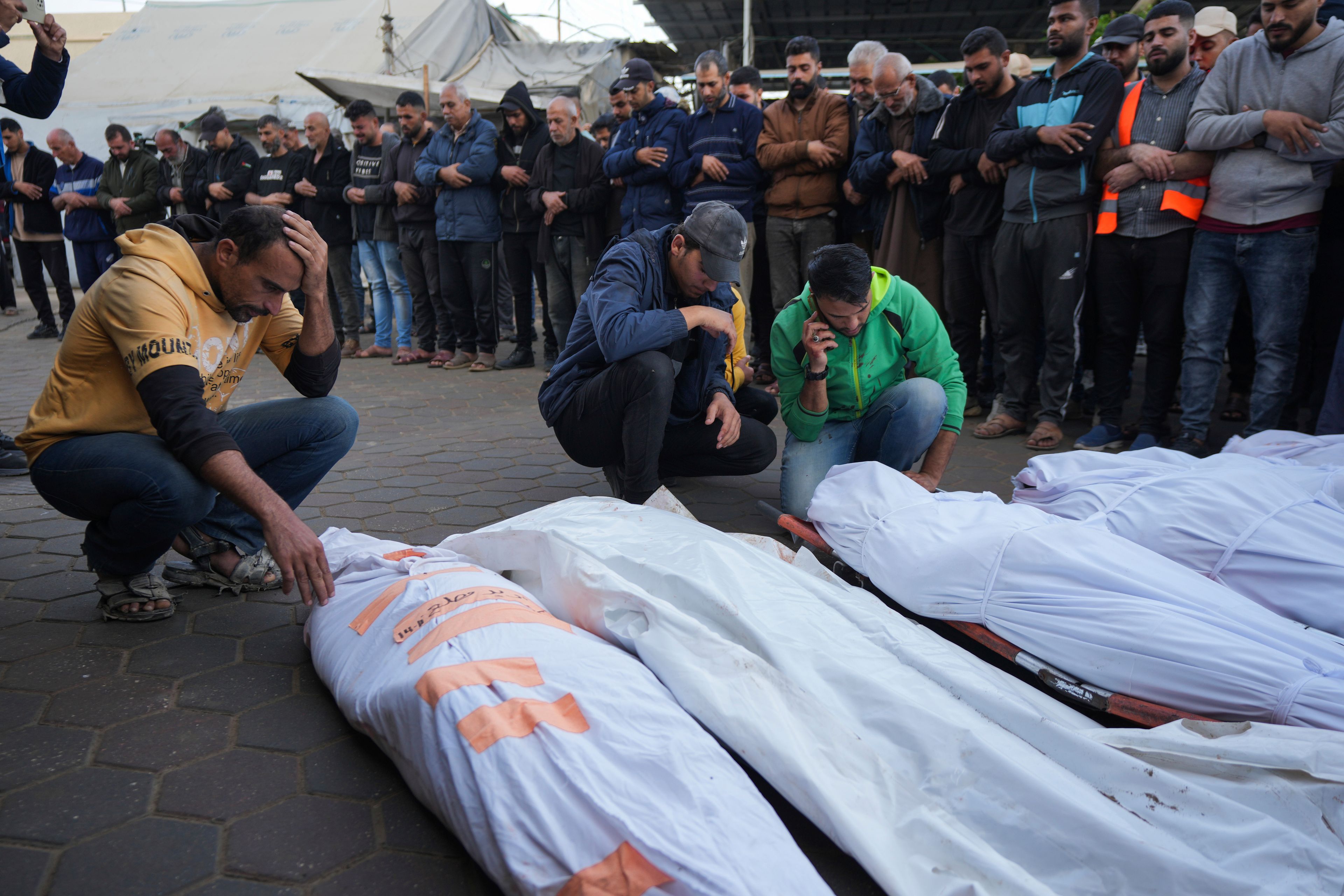 Palestinians mourn their relatives killed in the Israeli bombardment of Maghazi in the Gaza Strip, during their funeral at a hospital morgue in Deir al-Balah, Gaza, Thursday, Nov. 14, 2024. (AP Photo/Abdel Kareem Hana)