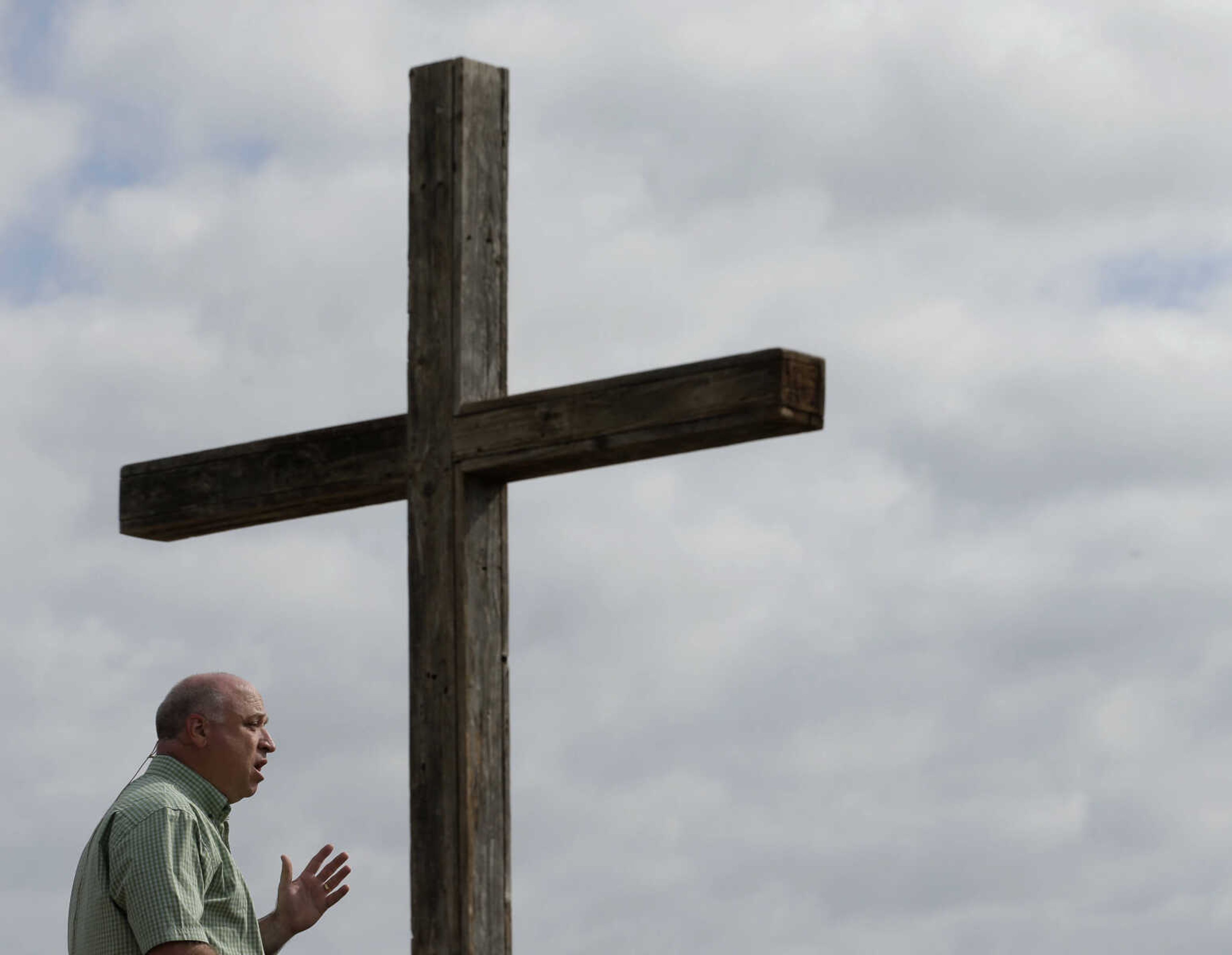 Pastor John Crowder talks to his congregation during a service for the First Baptist Church held in a field Sunday, April 21, 2013, four days after an explosion at a fertilizer plant in West, Texas. The church could not meet in their building because it was in a damage zone after a massive explosion at the West Fertilizer Co. Wednesday night that killed 14 people and injured more than 160. (AP Photo/Charlie Riedel)