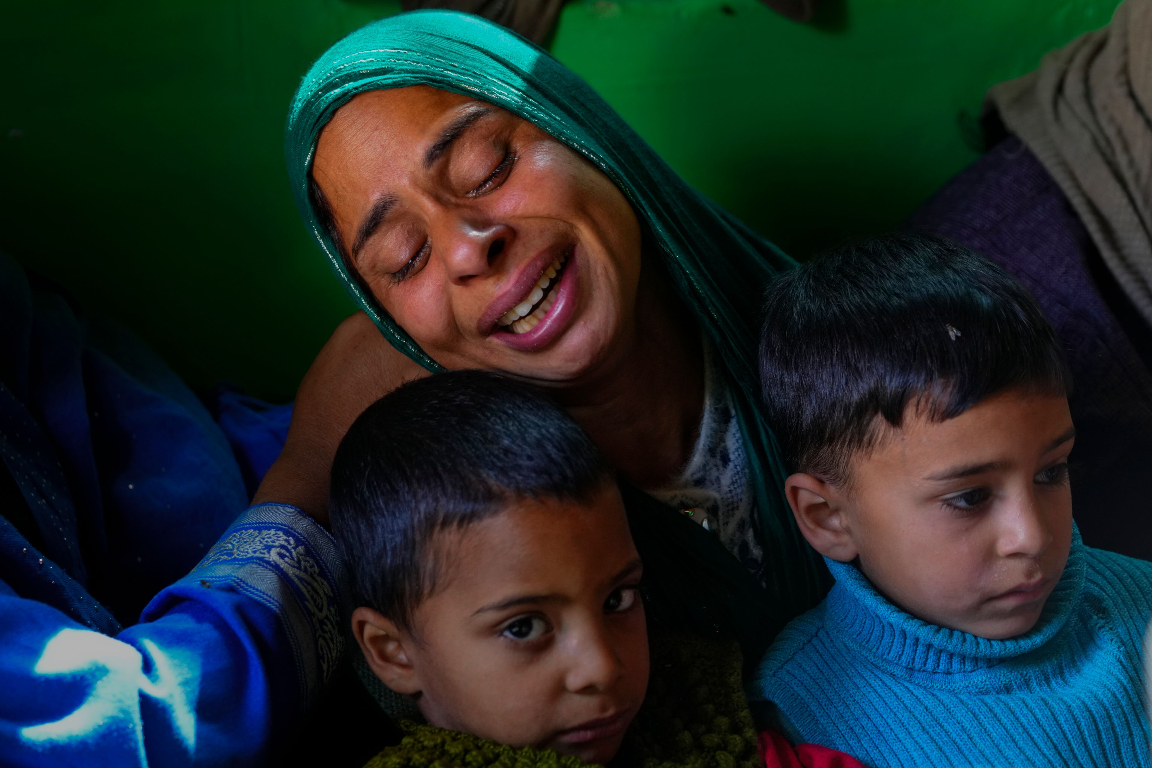 Gulshan Begum grieves holding her sons Rihan Zahhor, right and Arhan Zahoor, during the funeral of her husband Zahoor Ahmad, an army porter who was among those killed in a rebel ambush on an army vehicle previous night, in Boniyar, north of Srinagar, Indian controlled Kashmir, Friday, Oct. 25, 2024. (AP Photo/Dar Yasin)