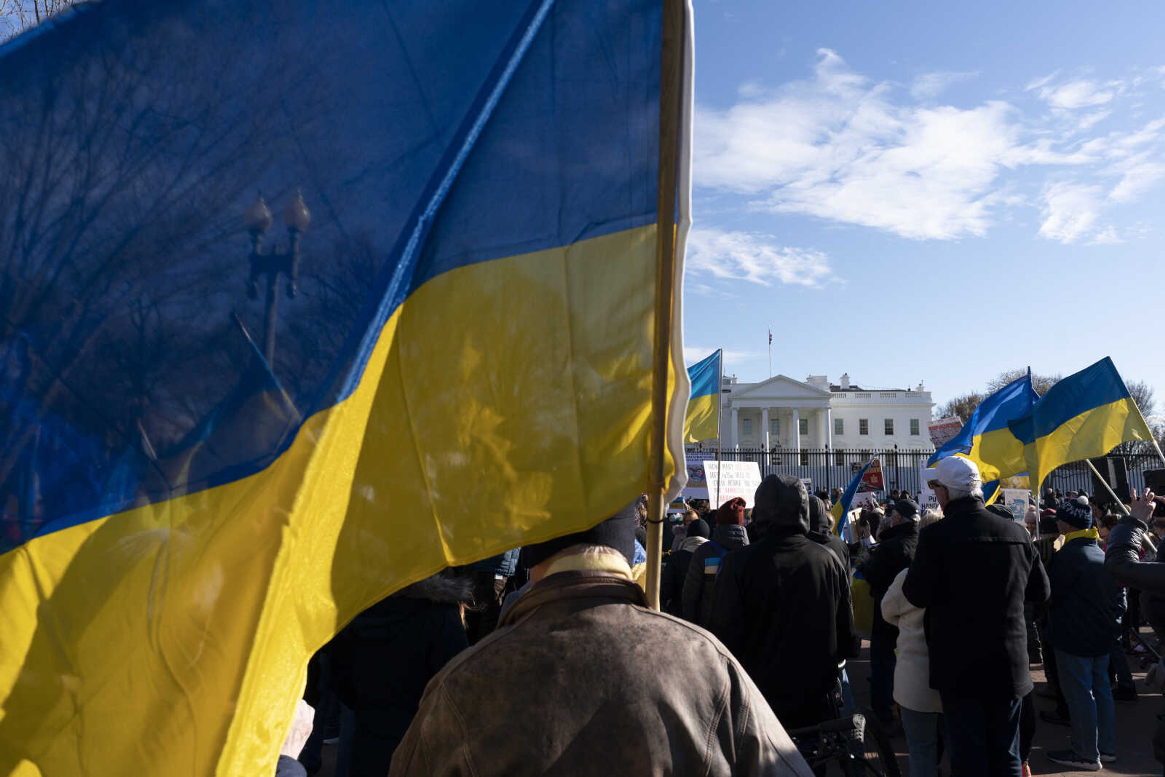 FILE - Activists protest the Russian invasion of Ukraine in Lafayette Park near the White House, Sunday, March 13, 2022, in Washington. The Biden administration is allowing thousands of Ukrainians who fled their homeland when Russia invaded a year ago to stay in the United States longer. The administration announced the decision Monday, March 13, 2023. (AP Photo/Alex Brandon, File)