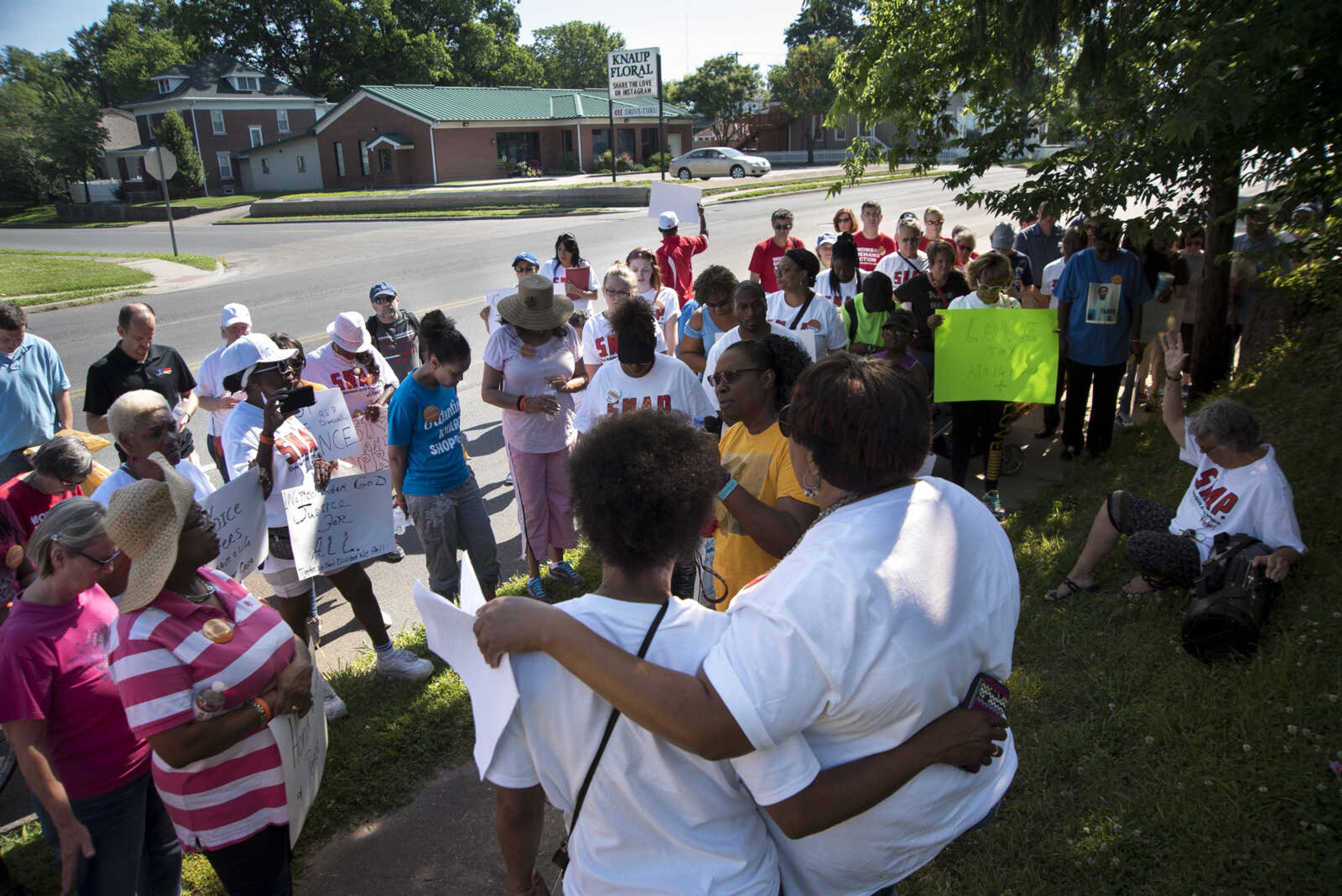 Community Members say a prayer during a Stop Needless Acts of Violence Please (SNAP) prayer march Saturday, June 10, 2017 in Cape Girardeau.