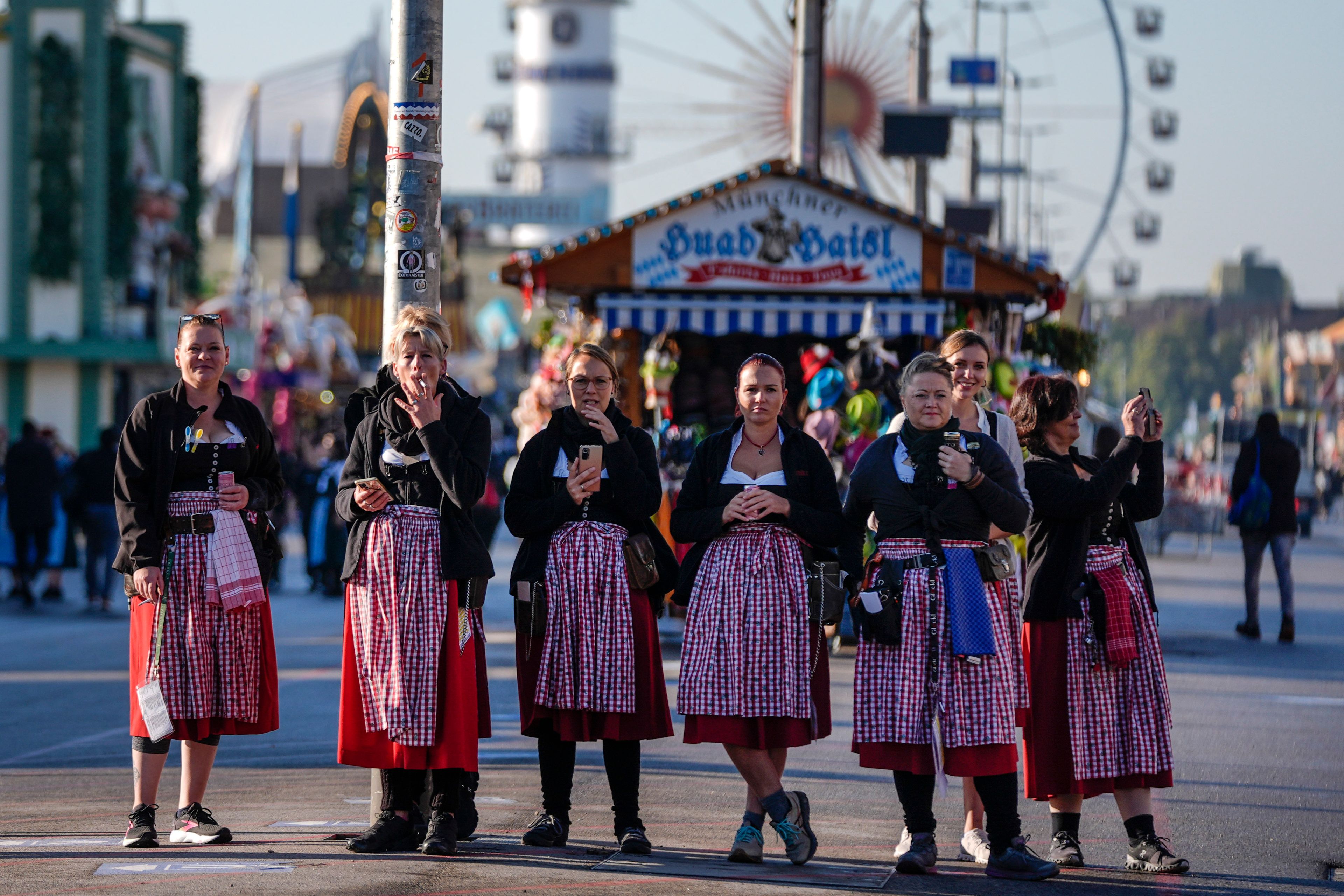 Waitresses wait for the gates to open, before the start of the 189th 'Oktoberfest' beer festival in Munich, Germany, Saturday, Sept. 21, 2024. (AP Photo/Matthias Schrader)