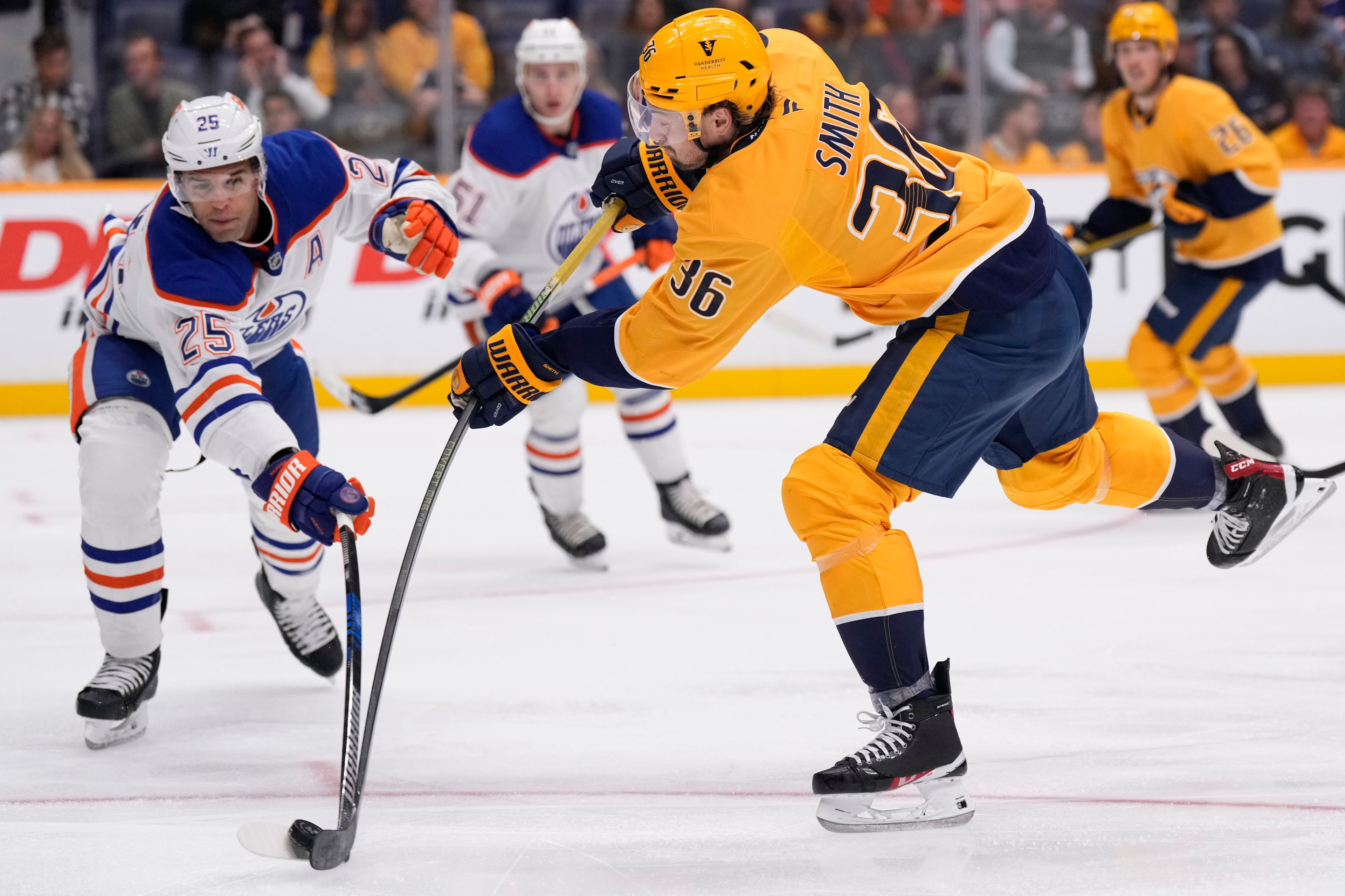 Nashville Predators left wing Cole Smith (36) shoots the puck past Edmonton Oilers defenseman Darnell Nurse (25) during the second period of an NHL hockey game Thursday, Oct. 17, 2024, in Nashville, Tenn. (AP Photo/George Walker IV)