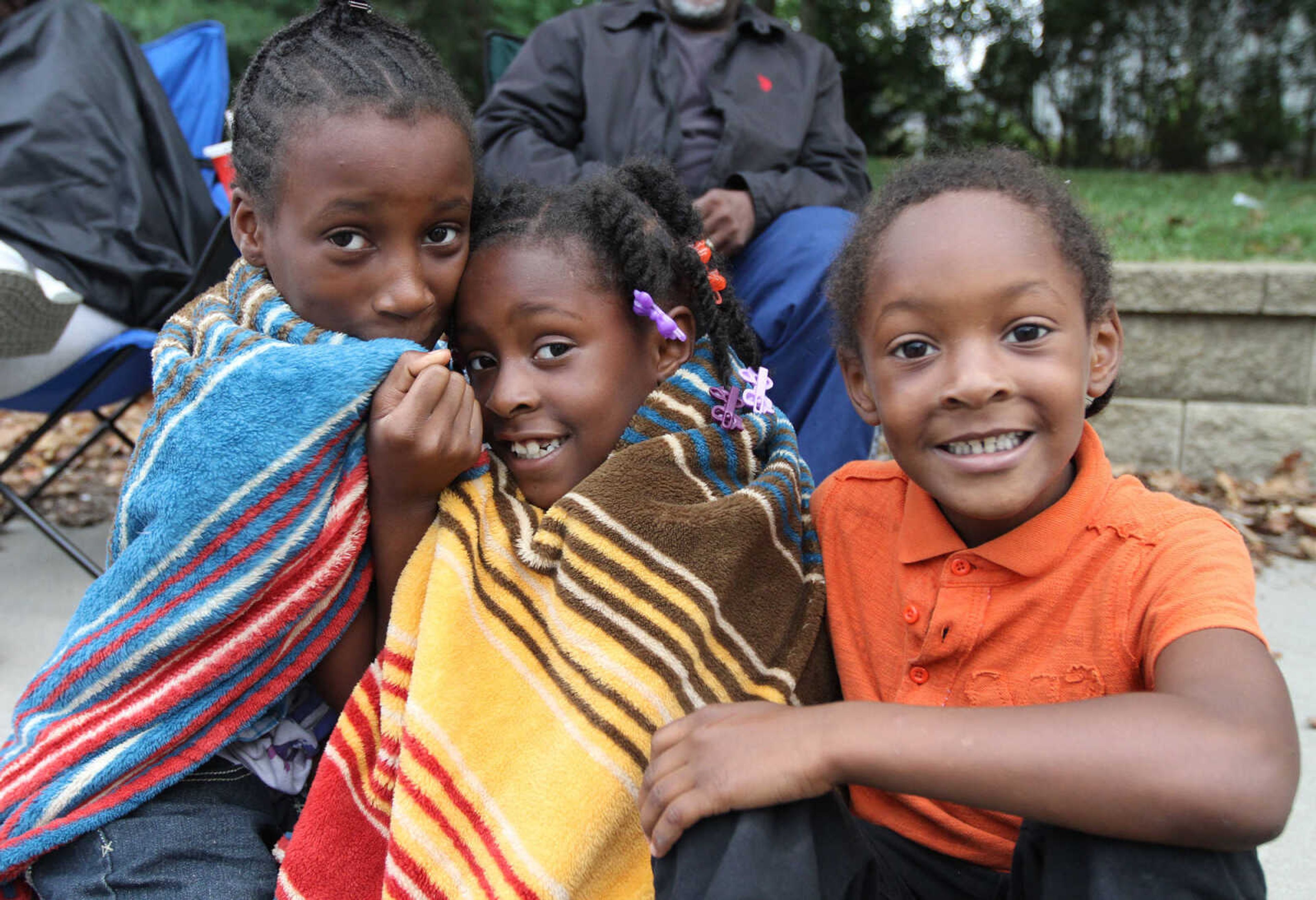 GLENN LANDBERG ~ glandberg@semissourian.com

Tahlesa Garmon, left, Brianna and C.J. West wait for the SEMO District Fair Parade to start Saturday morning, Sept. 6, 2014, in Cape Girardeau. The parade ended at Arena Park where the 159th annual SEMO District Fair is being held.