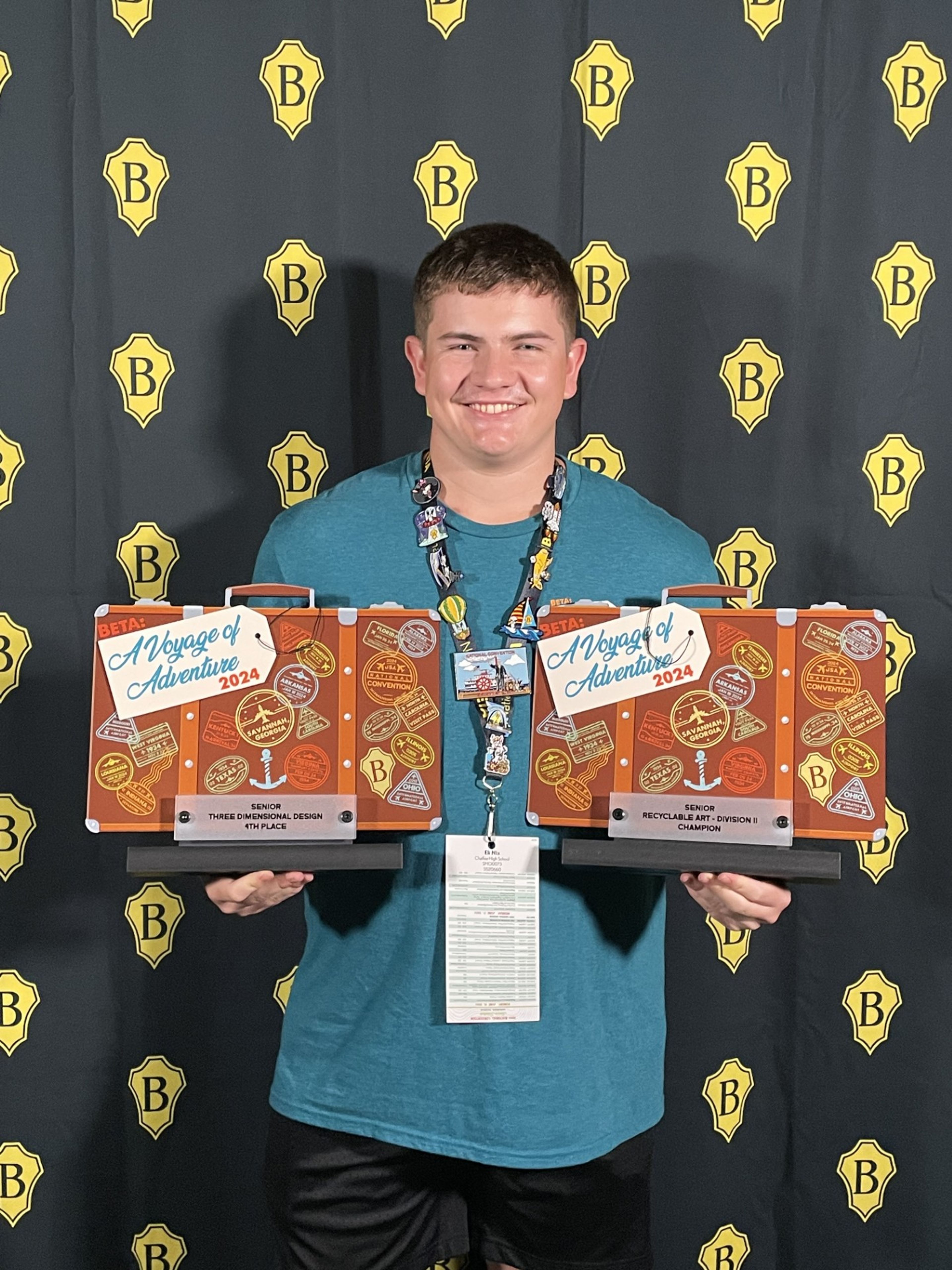 Eli Nix holds his two awards from BETA Nationals. He won first in Recyclable art and fourth in Three-dimensional design. 