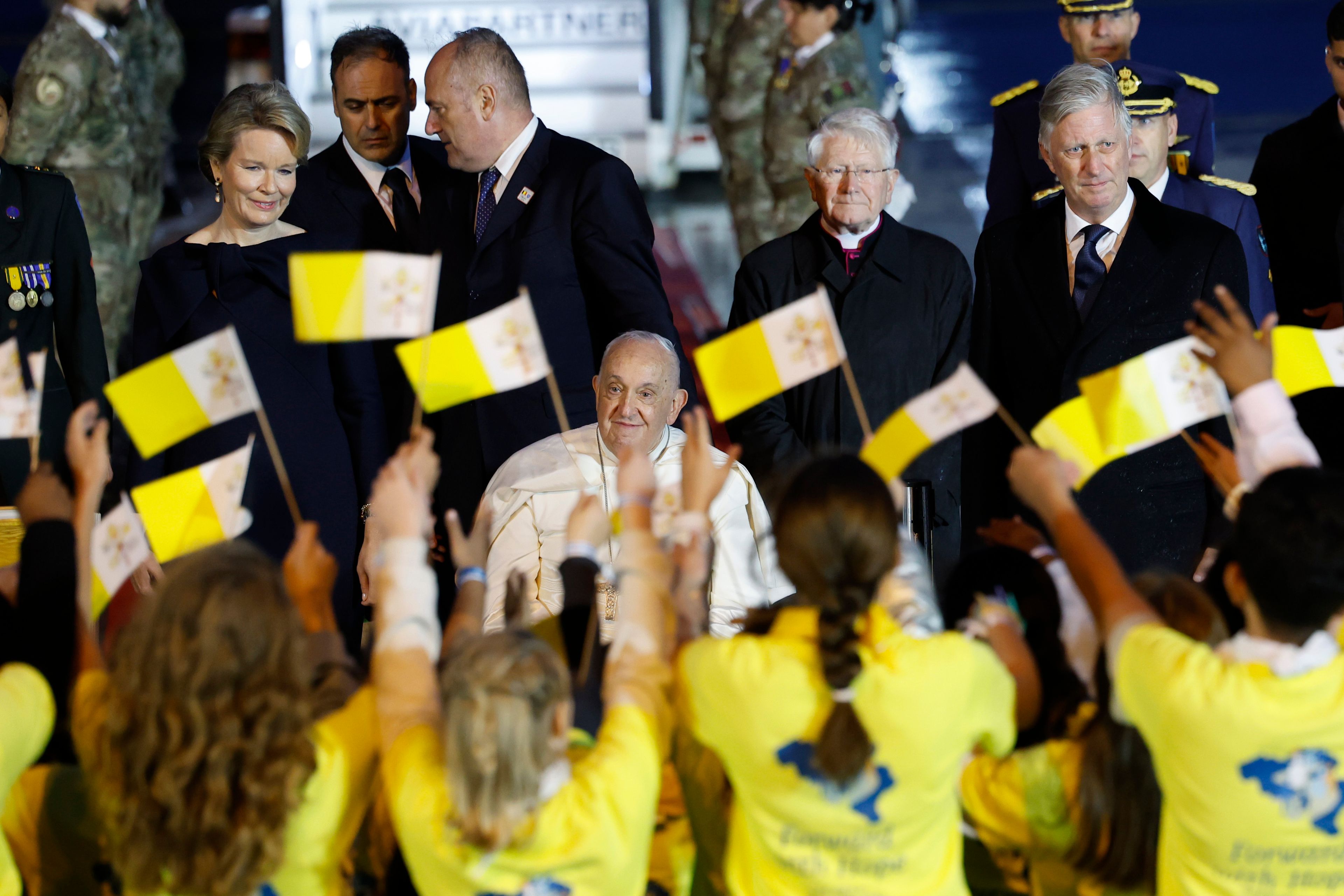 Pope Francis arrives flanked by Queen Mathilde of Belgium and King Philippe of Belgium, at Melsbroek air base in Steenokkerzeel, near Brussels, on the first day of his four-day visit to Luxembourg and Belgium, Thursday, Sept. 26, 2024. (AP Photo/Geert Vanden Wijngaert)