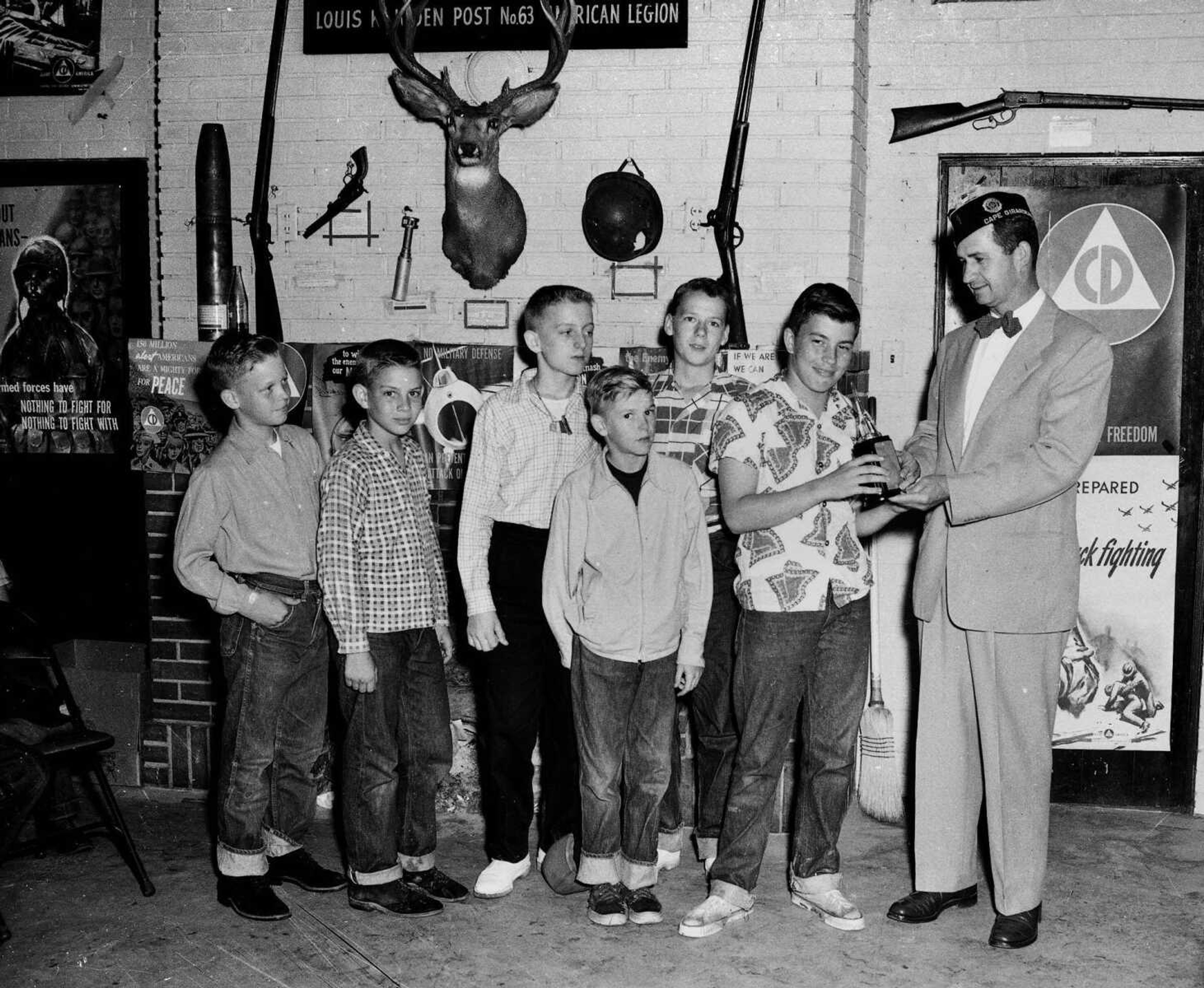 A representative of the Louis K. Juden Post of the American Legion awarded a trophy to this group of youngsters. Note the arsenal on the wall behind the youths, as well as the Civil Defense posters. Drop a note to librarian Sharon Sanders at ssanders@semissourian.com, if you can provide information about this image