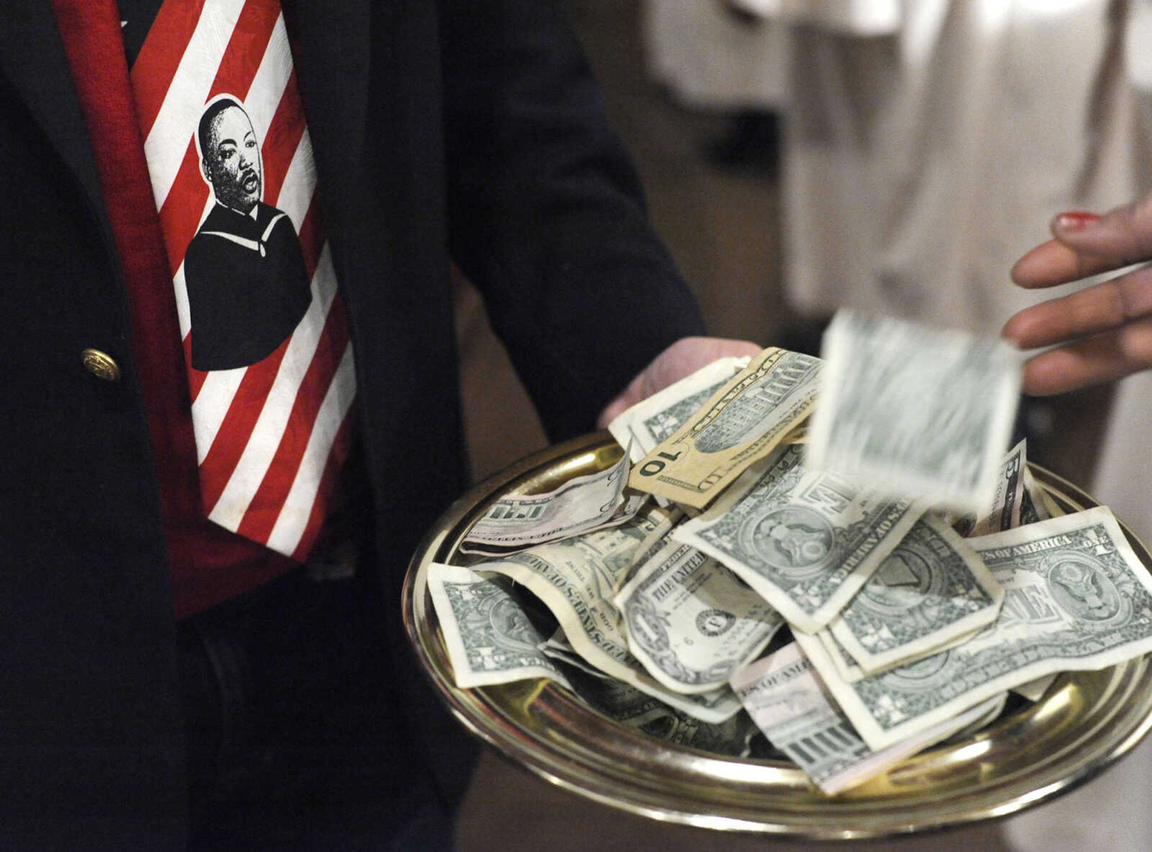 An offering for academic scholarships is received at the Dr. Martin Luther King Jr. Community Celebration on Sunday, Jan. 17, 2016 at St. James AME Church.