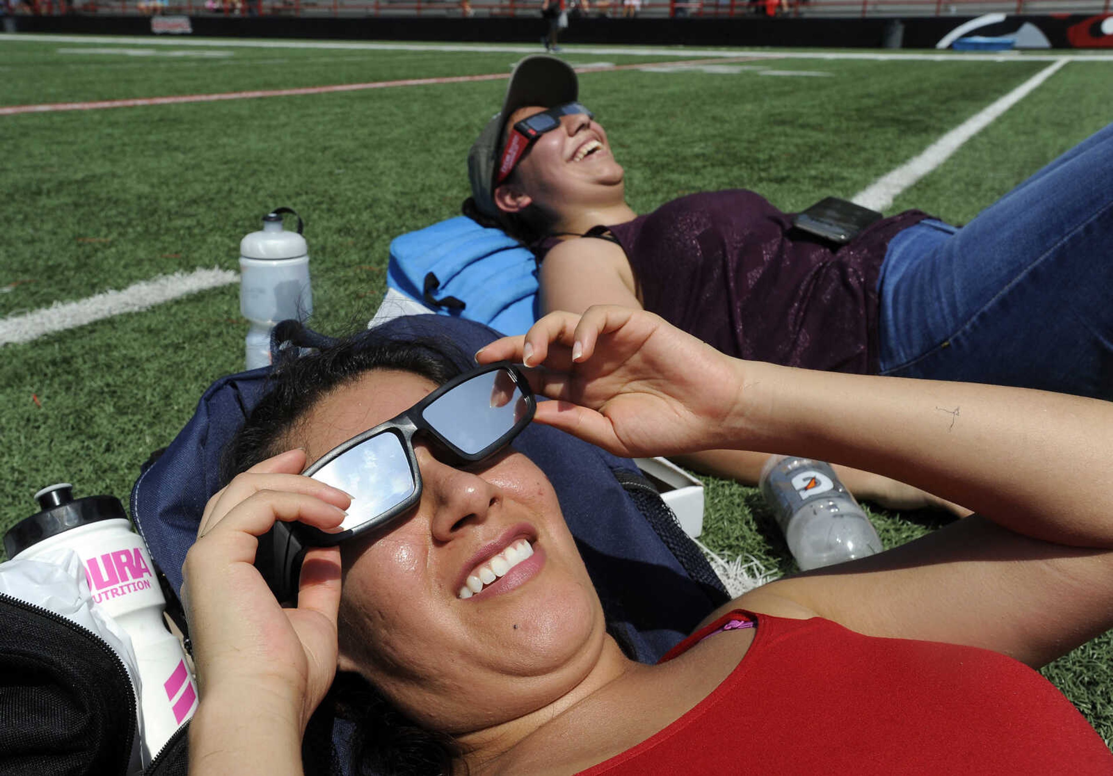 FRED LYNCH ~ flynch@semissourian.com
Andrea Herrera, front, and Veronica Morena with Space Center Houston look at the solar eclipse Monday, Aug. 21, 2017 at Houck Field in Cape Girardeau.