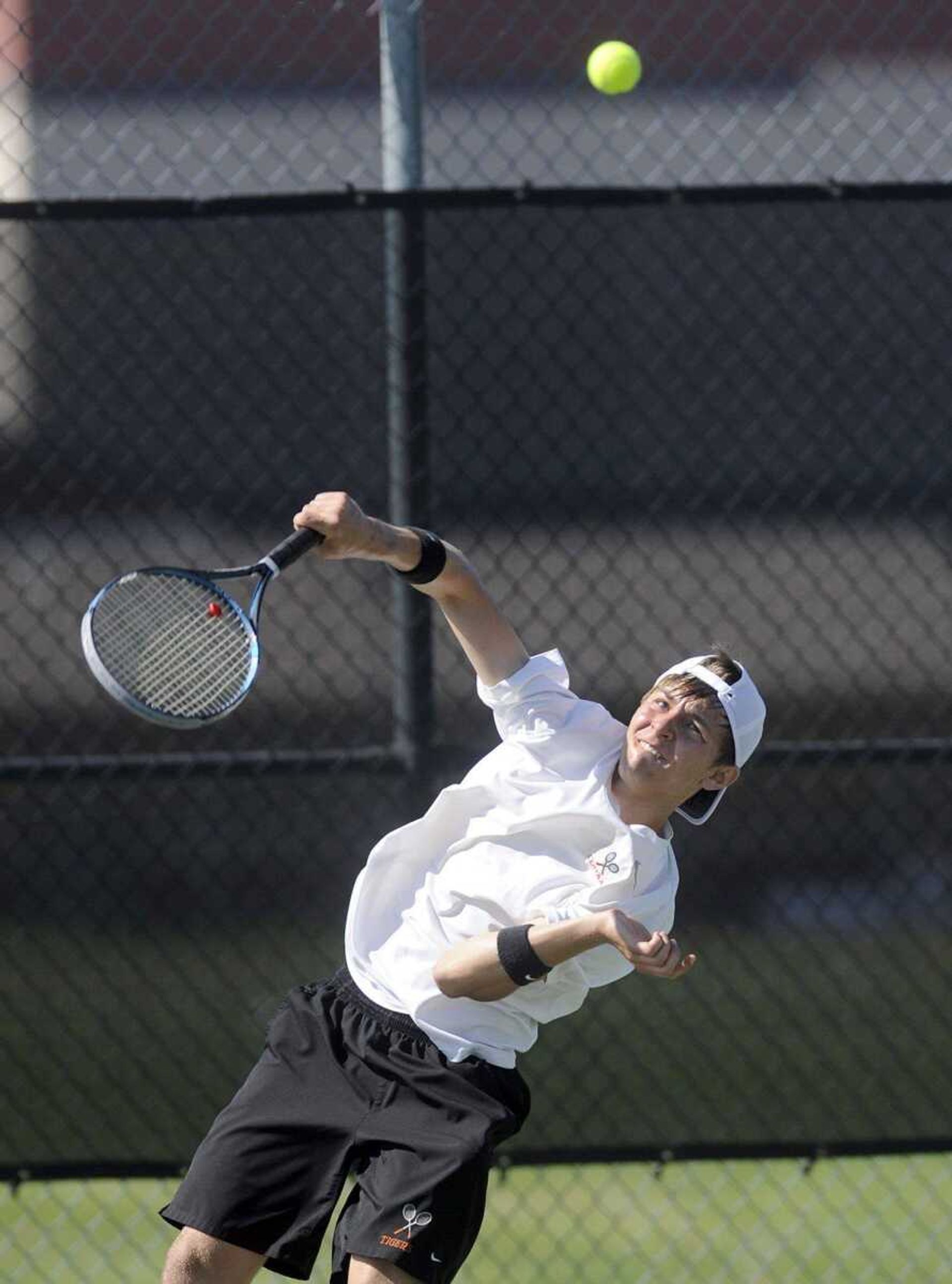 Central&#8217;s Jonah Roop serves during his singles match against Farmington&#8217;s James Kahn.