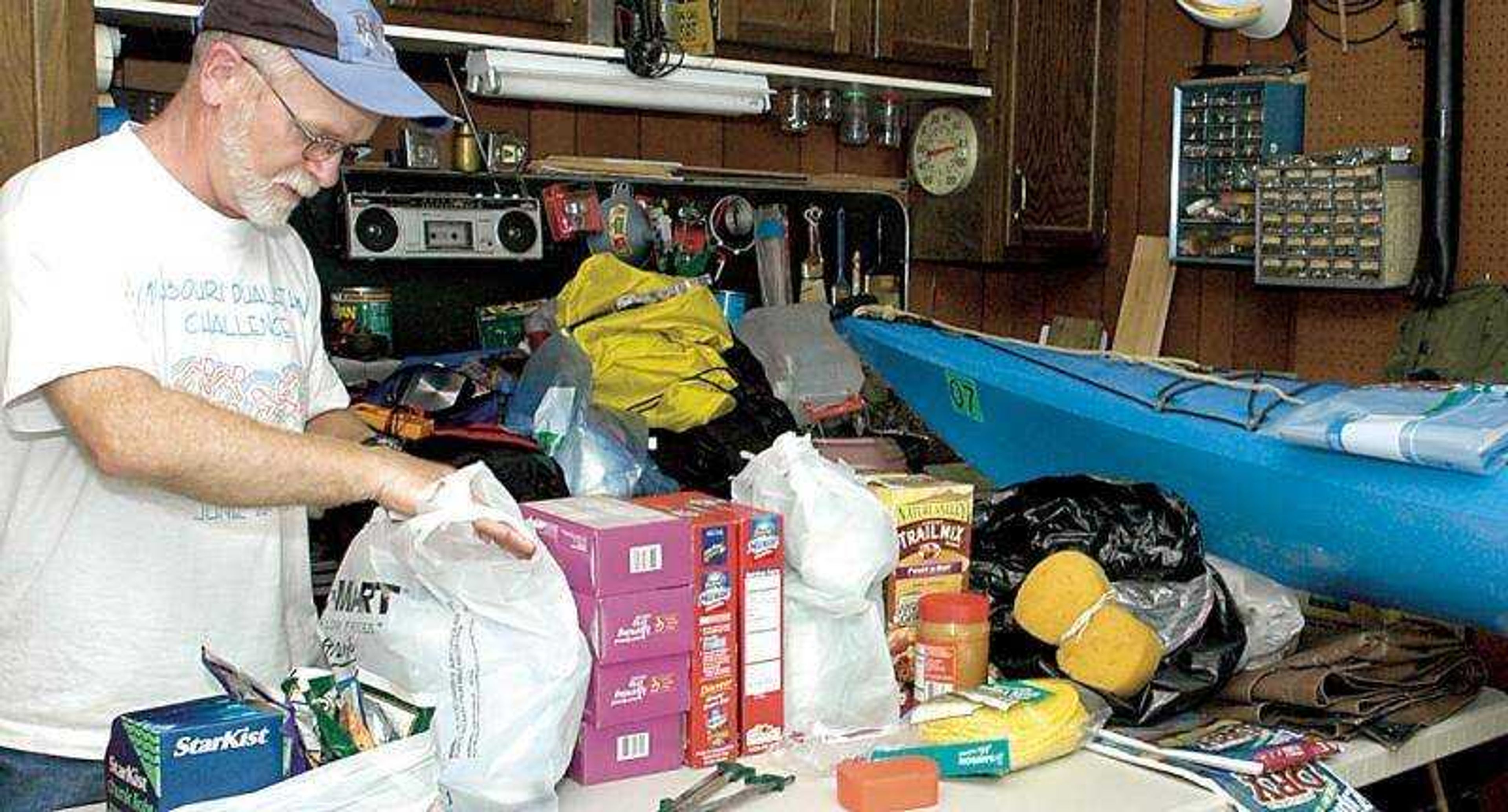 Dave Hardesty checked supplies in the garage of his Cape Girardeau home in preparation for a 1,300 mile kayak trip down the Mississippi.