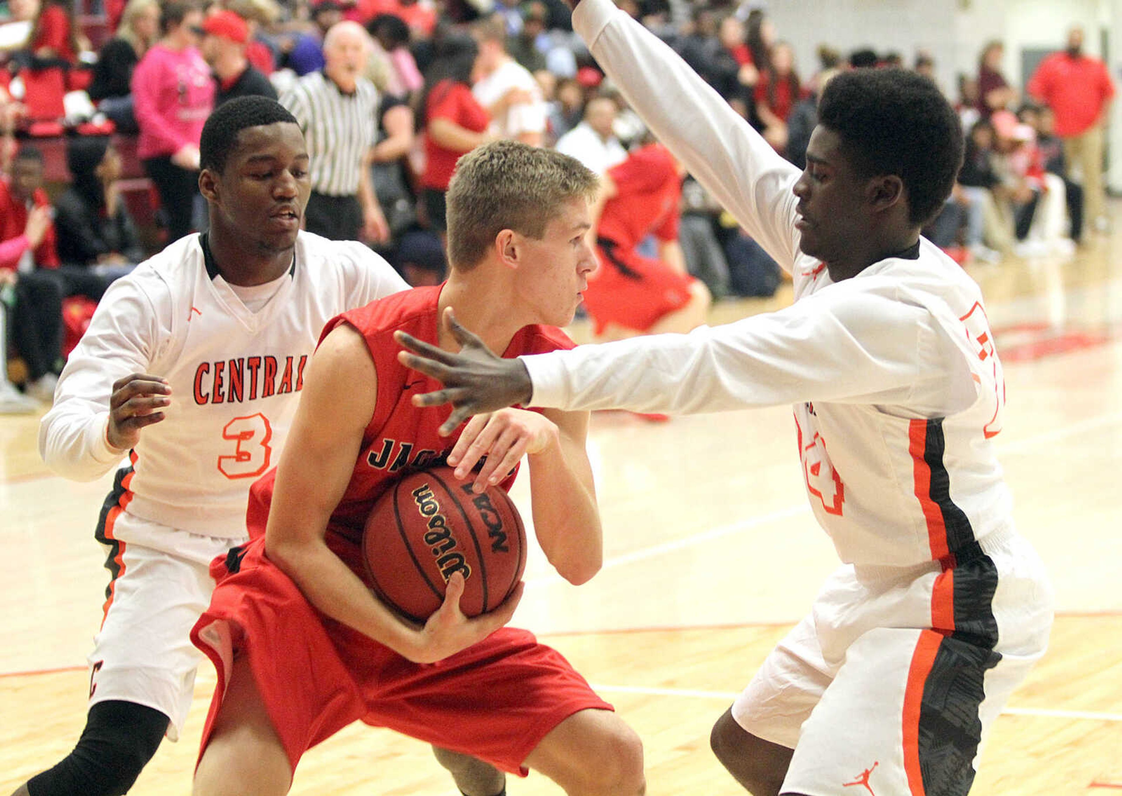 Cape Central's Al Young (left) and Kway'Chon Chisom double team Jackson's Jacob Friess in the consolation finals of the SEMO Conference Tournament on Friday night at the Sikeston Field House. (David Jenkins/Standard Democrat)