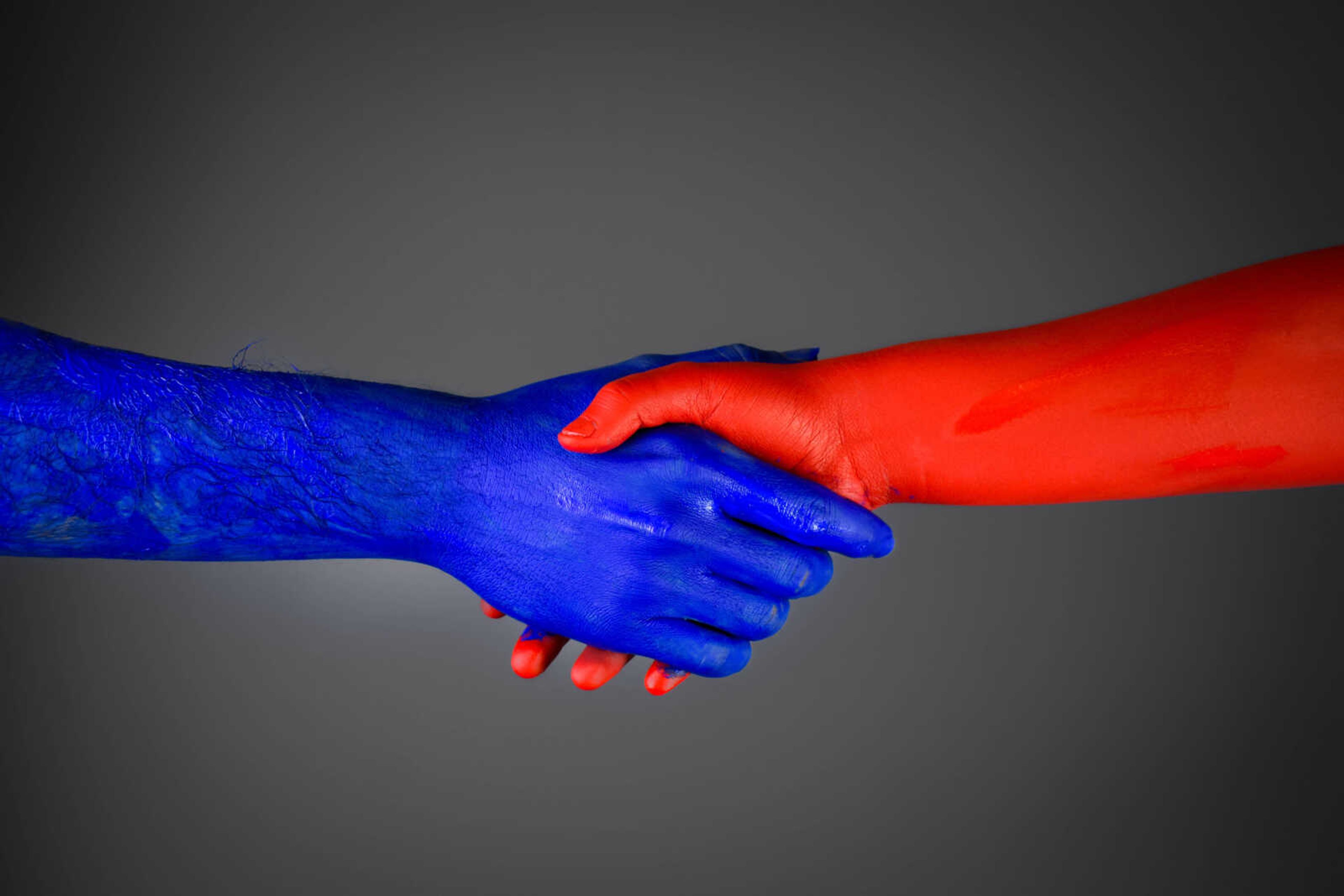 College Democrats president Brock Freeman and College Republicans president Bailee Cairel shake hands as they set aside their ideological differences and work together to promote voter registration. 